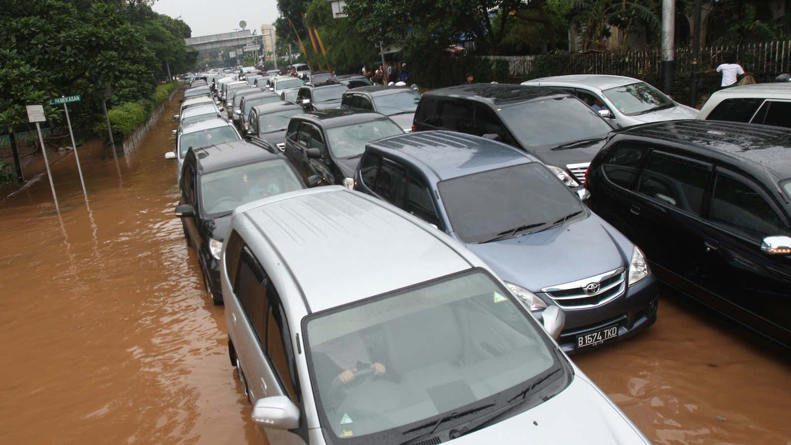 Gridlocked traffic on Jakarta’s flooded roads: the reality of Indonesia’s mismanaged economic boom.