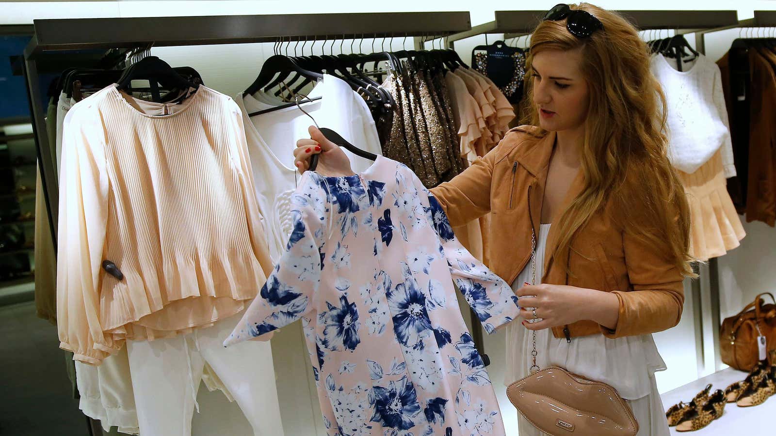 A woman looks at clothes inside a Zara store in central Madrid March 18, 2014. Inditex, the world’s biggest fashion retailer, will accelerate investment in…