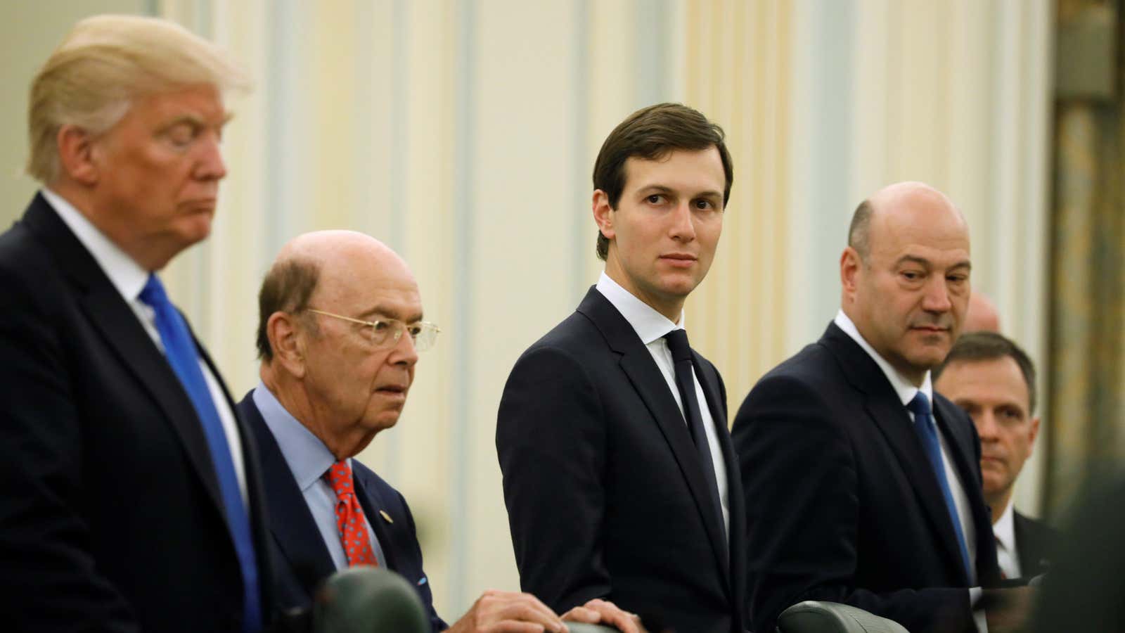 White House senior advisor Jared Kushner (C) sits alongside U.S. President Donald Trump (L), Commerce Secretary Wilbur Ross (2nd L) and chief economic advisor Gary Cohn.