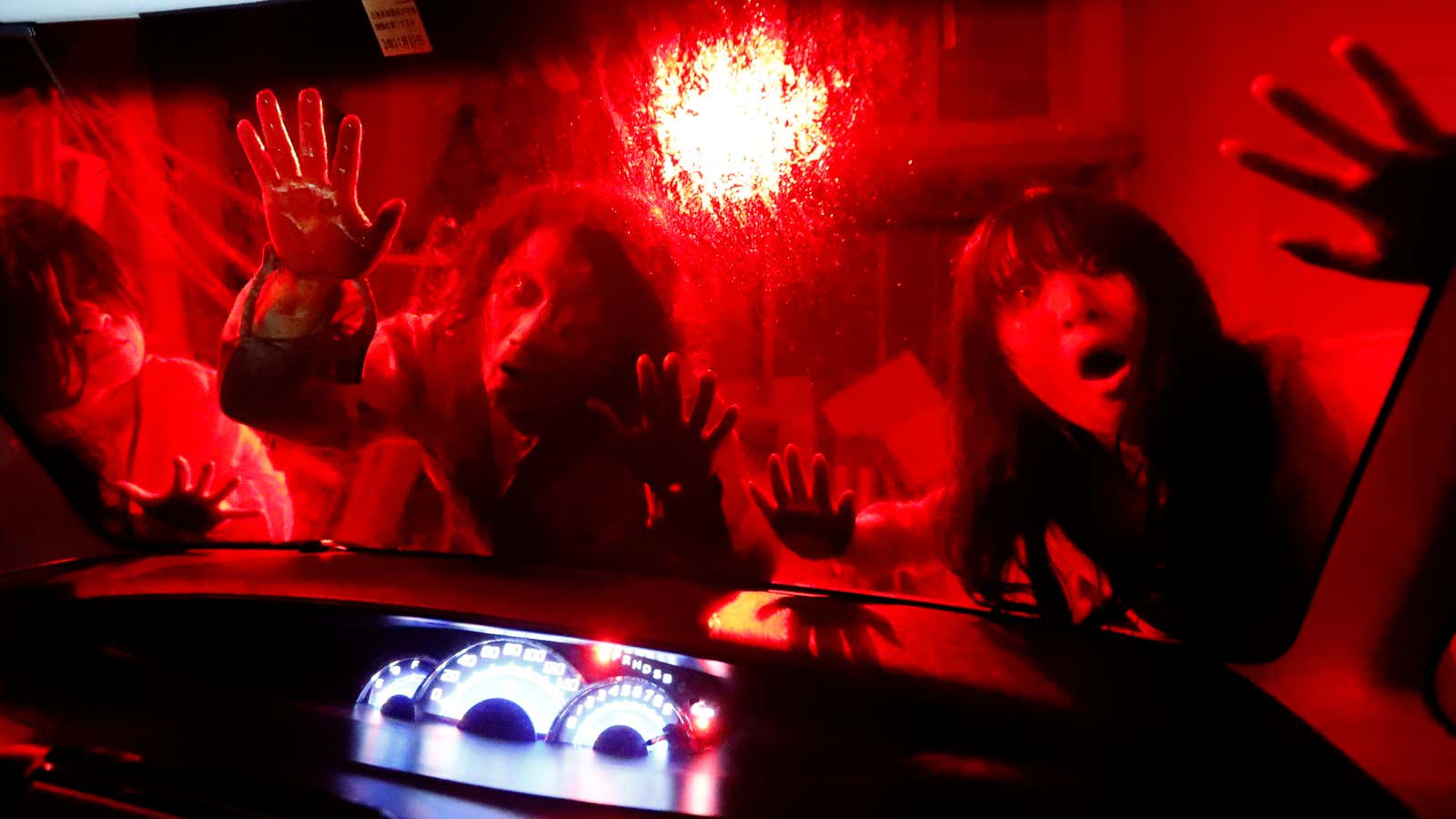 Actors dressed as zombies or ghouls perform during a drive-in haunted house show by Kowagarasetai (Scare Squad), for people inside a car in order to maintain social distancing amid the spread of the coronavirus disease (COVID-19), at a garage in Tokyo, Japan July 3, 2020.  REUTERS/Issei Kato