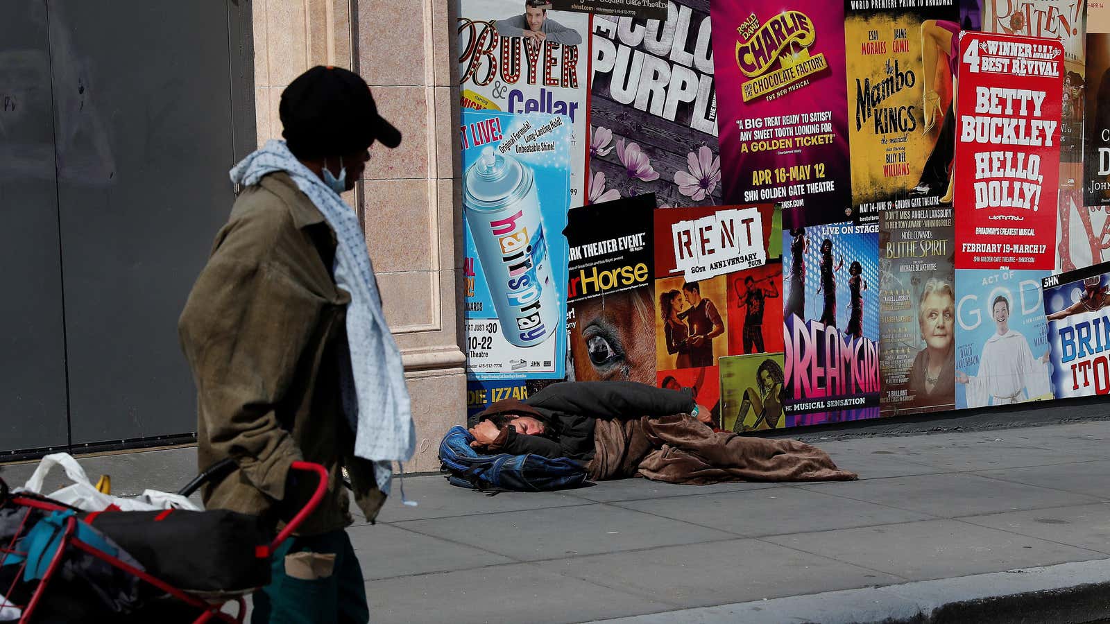 A man sleeps on the sidewalk amid an outbreak of Covid-19 in San Francisco, California.