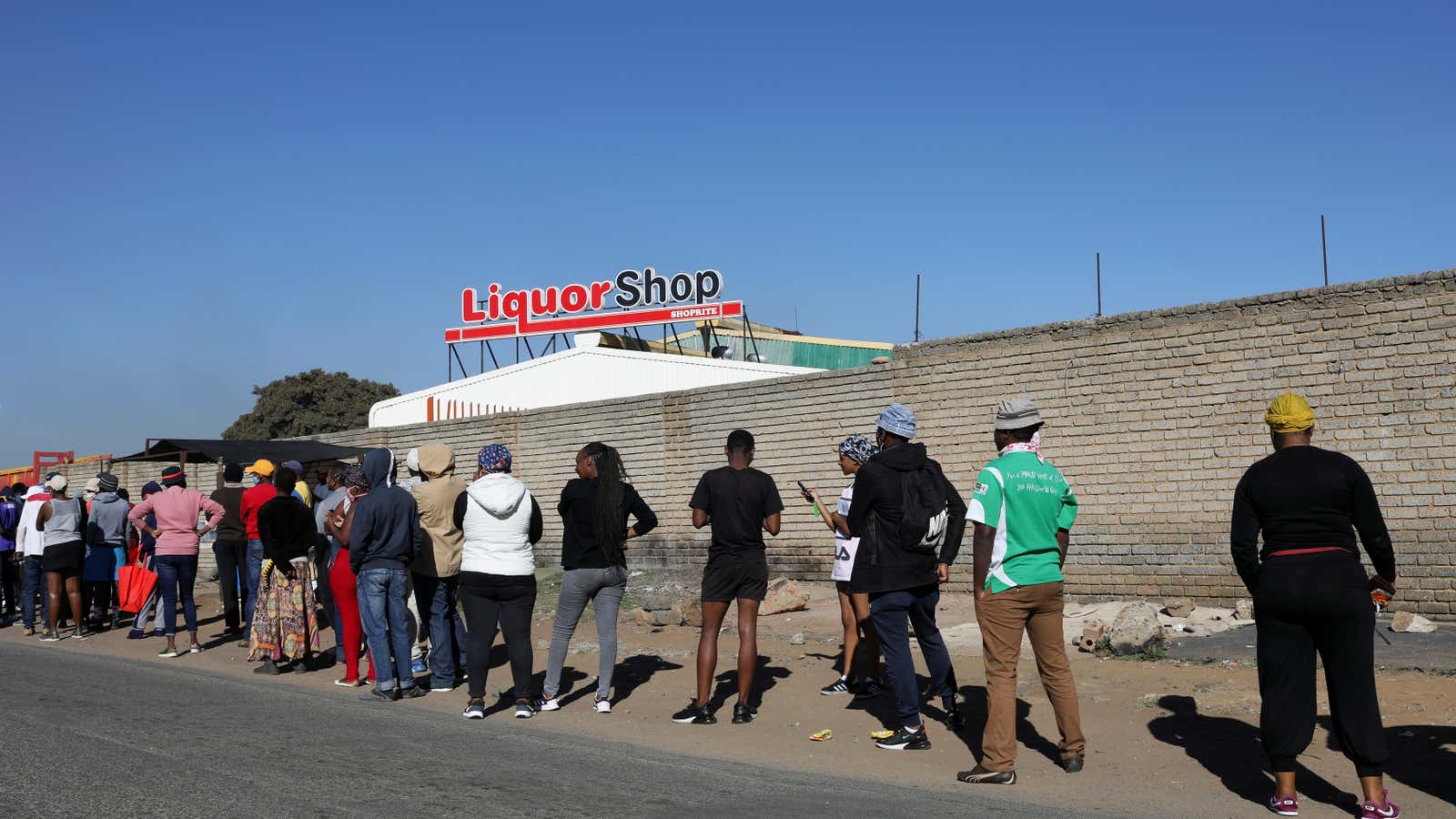 People wait in line to buy alcohol as South Africa lifts a lockdown lasting two months, in Soweto, South Africa June 1, 2020.