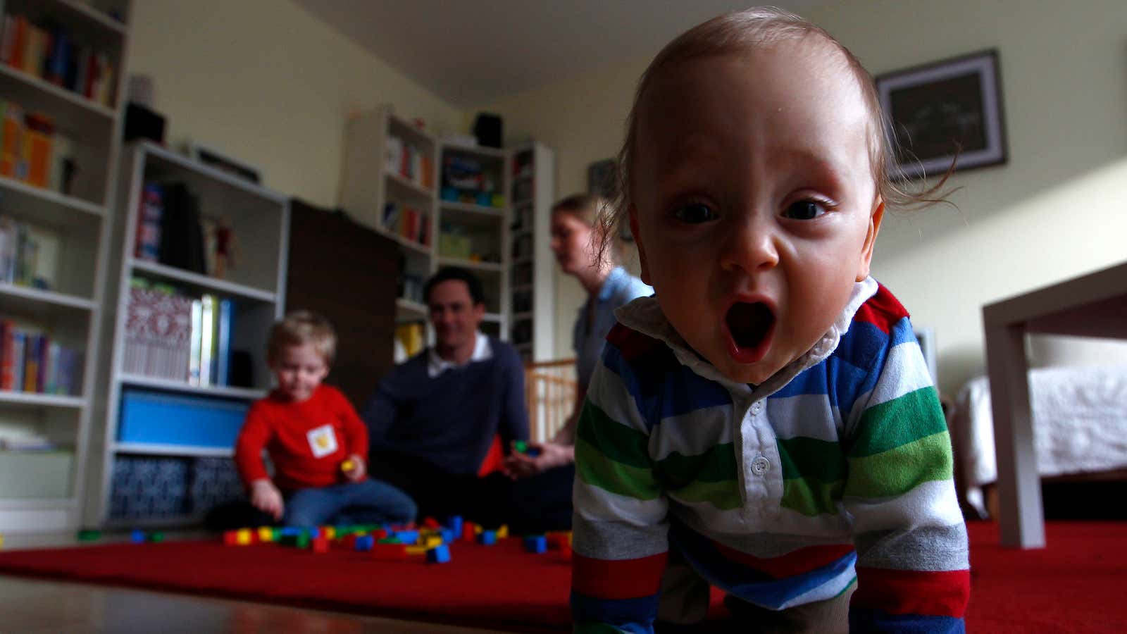 Ten-month old Leonard Rixom plays with his brother Benjamin (2) and his parents Veronika and Barry in their living-room in Ismaning near Munich November 8,…