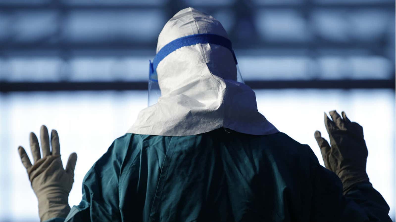 A health worker demonstrates protective equipment during an Ebola education session in New York.