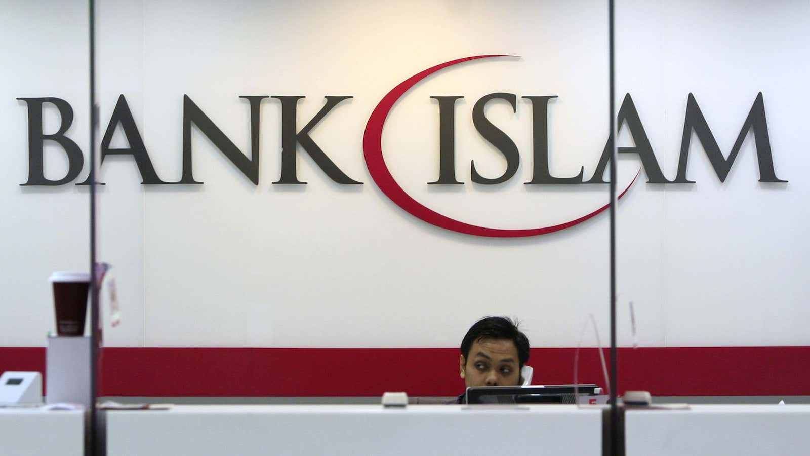 A bank staff speaks on the phone inside the Bank Islam branch office in Shah Alam, outside Kuala Lumpur November 6, 2013. London has long…