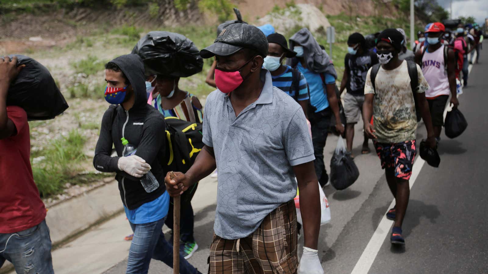 African, Cuban, and Haitian migrants, which are stranded in Honduras after borders were closed due to the coronavirus disease outbreak, trek northward in an attempt to reach the United States, in Choluteca, Honduras June 2, 2020.