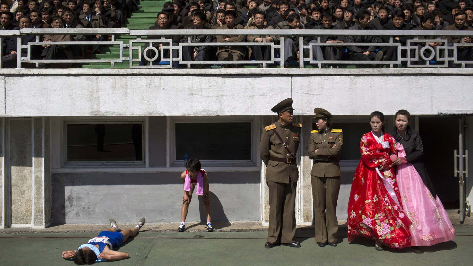 A runner rests inside Kim Il Sung stadium.