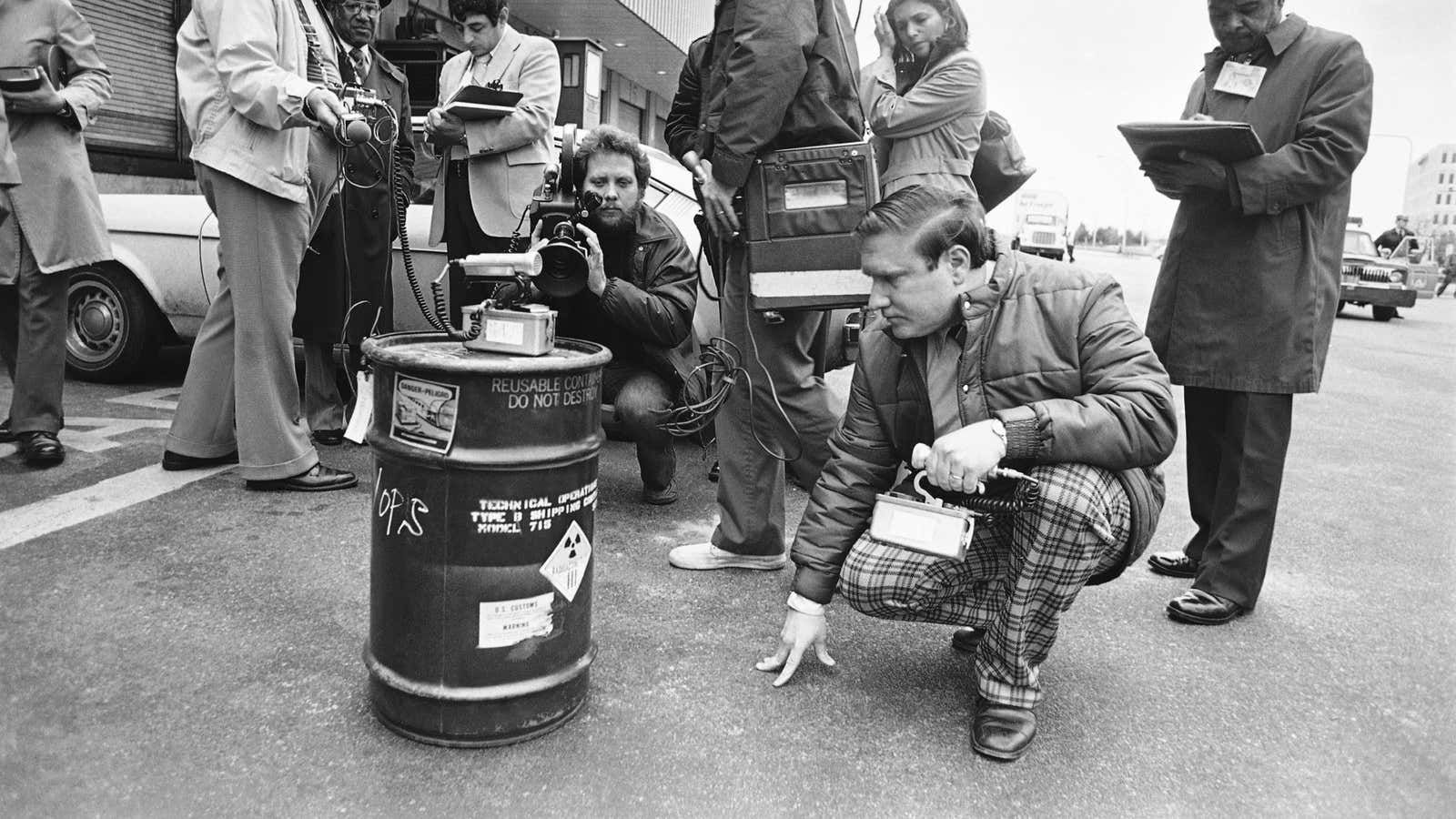 A scientist studies a steel drum containing iridium-192 on March 17, 1980. The radioactivity of his pants could not be determined.