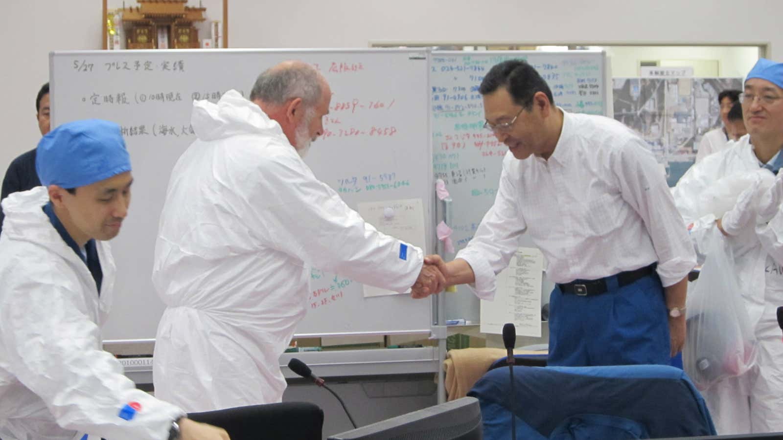 Masao Yoshida (2nd from right) greets nuclear inspector Mike Weightman.