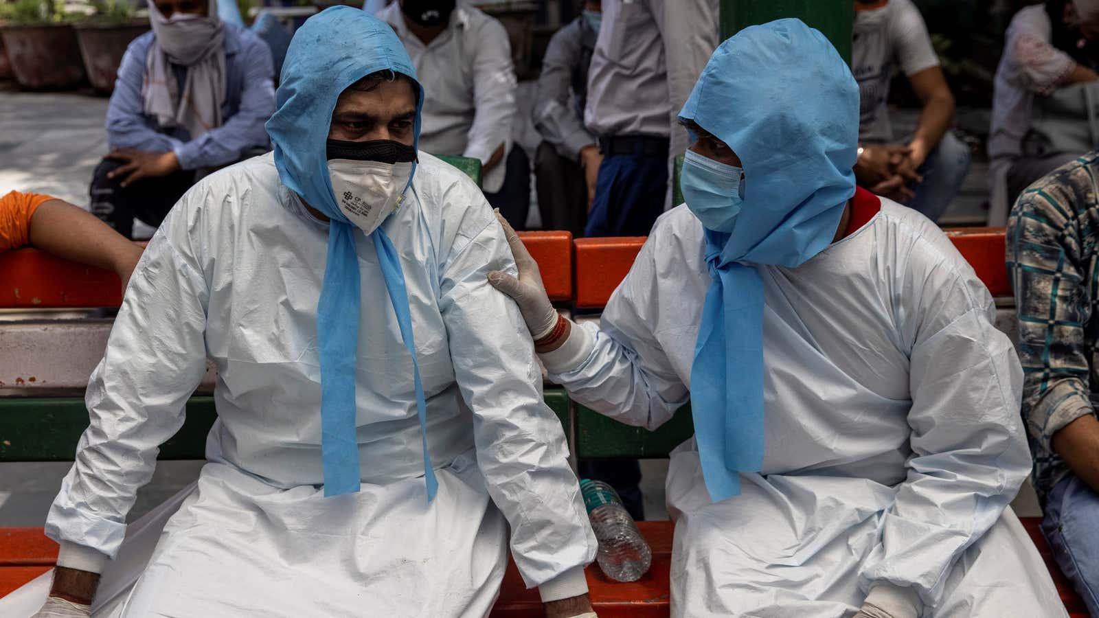 Brotherly support at a mass cremation site.