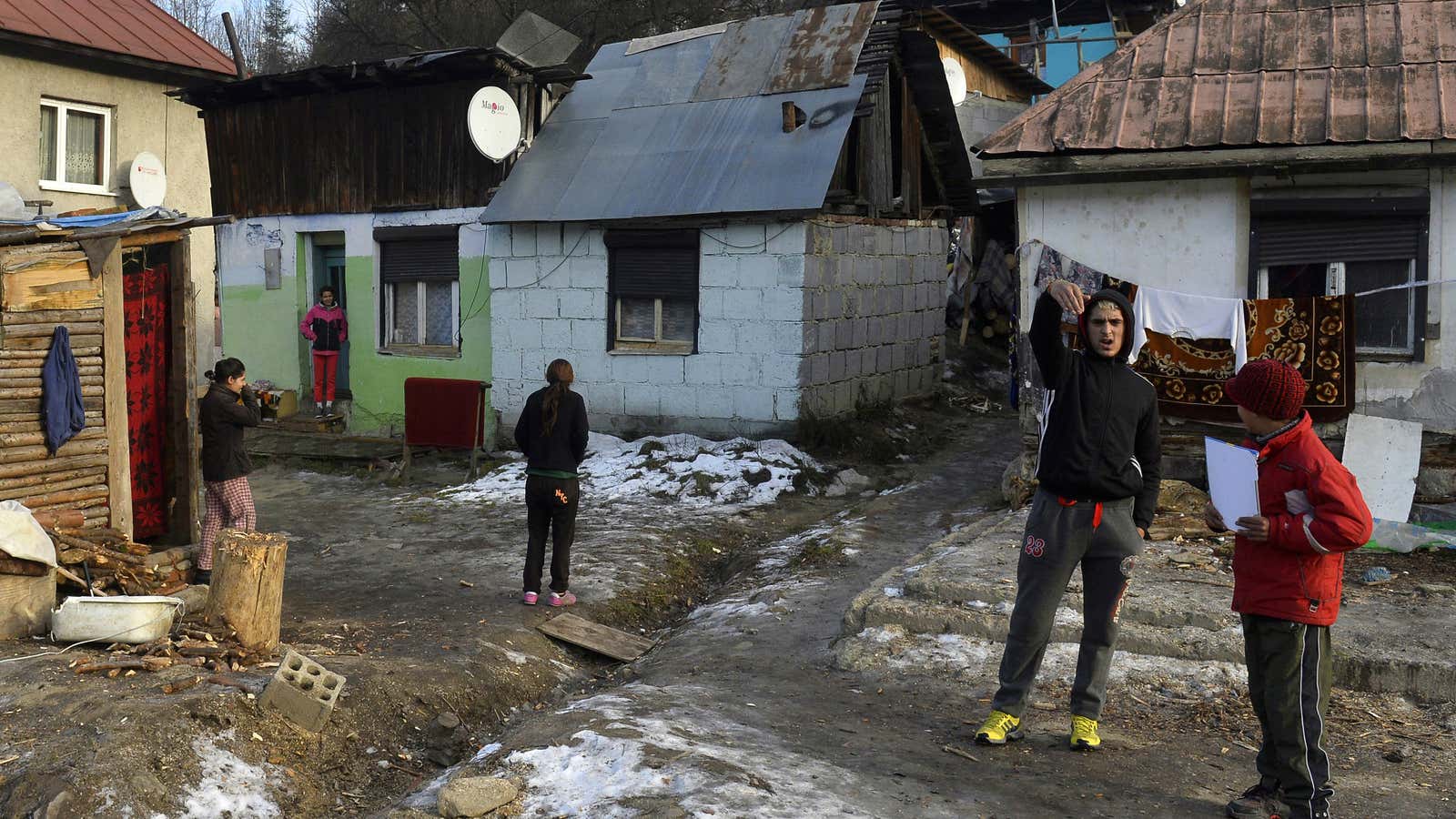 Members of the Roma community are seen in front their shacks that have no running water or sewerage in Cierny Balog.