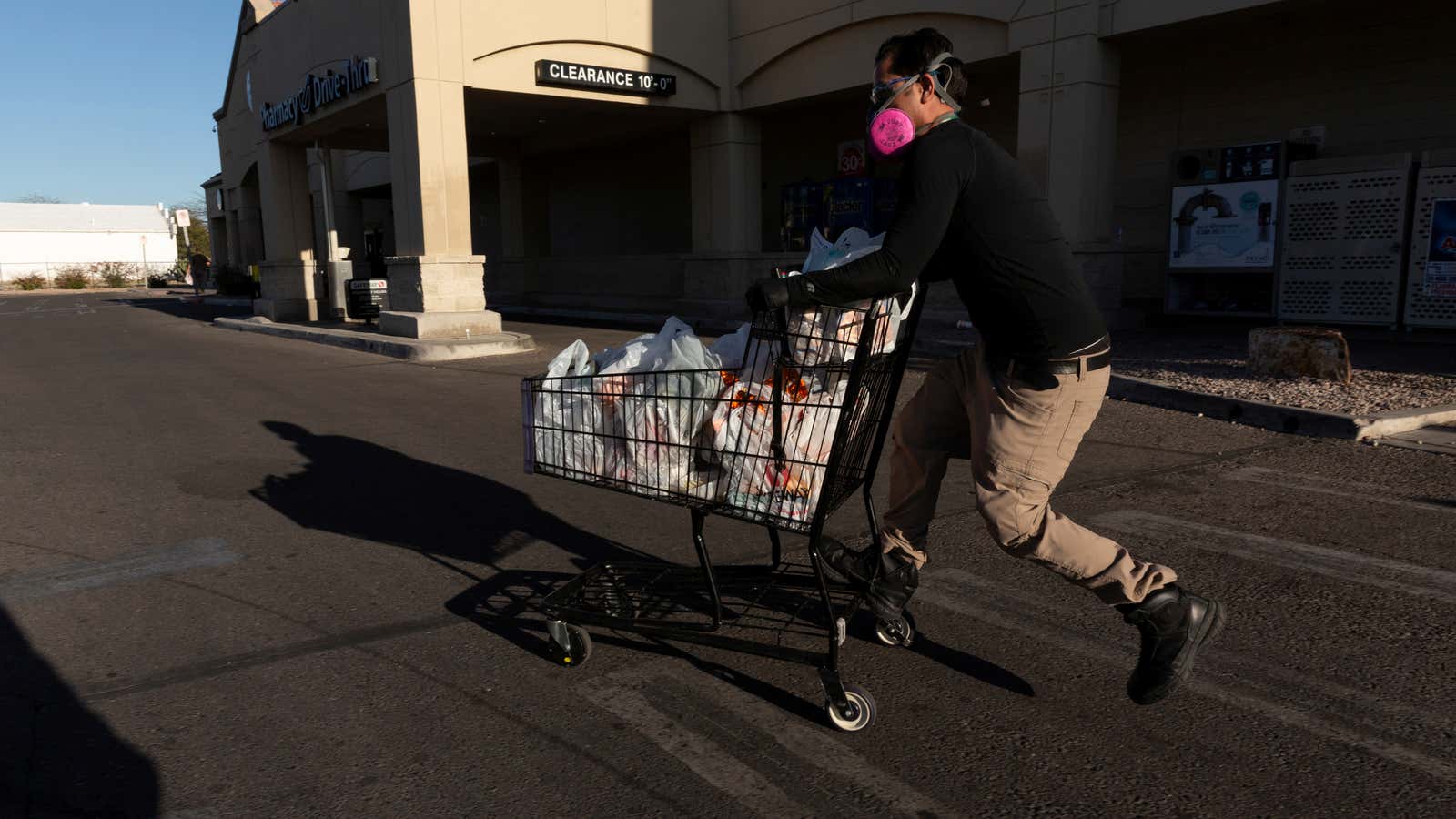 An Instacart employee runs to his car in the midst of grocery deliveries during the pandemic.