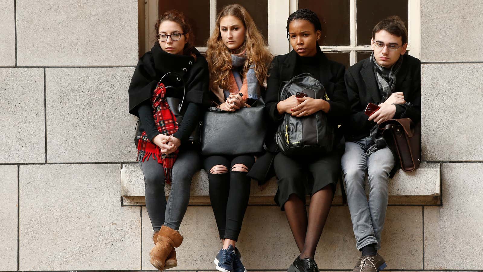 Students observe a minute of silence with French President Francois Hollande, Education Minister Najat Vallaud-Belkacem, and French Prime Minister Manuel Valls (unseen) at the Sorbonne University in Paris to pay tribute to victims of Friday’s Paris attacks, France, November 16, 2015.