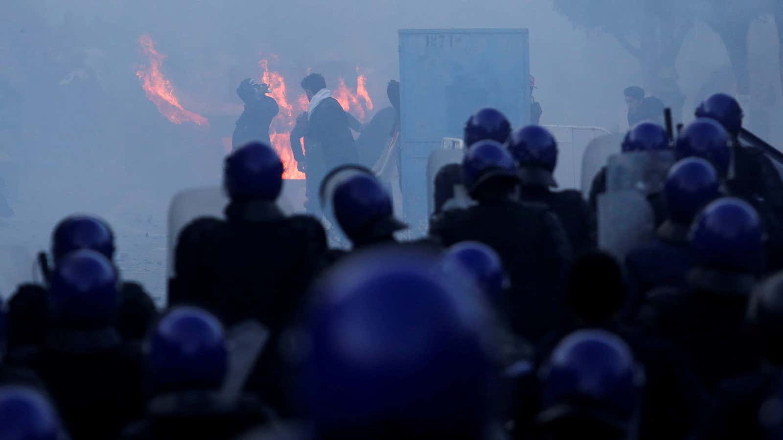 Police use tear gas to disperse crowds as people march to protest against President Abdelaziz Bouteflika’s plan to seek a fifth term in Algiers, Algeria, Feb.22, 2019.