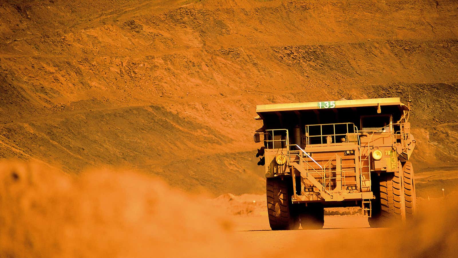 An earth mover in action at a BHP Billiton iron ore mine in Western Australia.