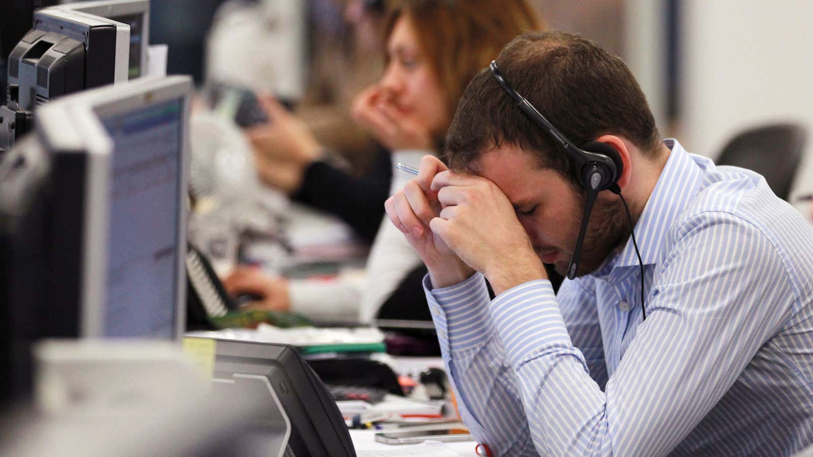 A worker on the IG Group’s trading floor looks away from his screens in the City of London, October 4, 2011. Britain’s top share index…