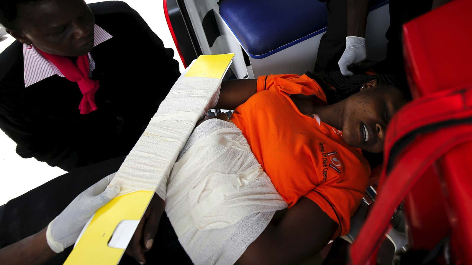 Paramedics assist a woman injured during a security exercise at Strathmore University in Nairobi.