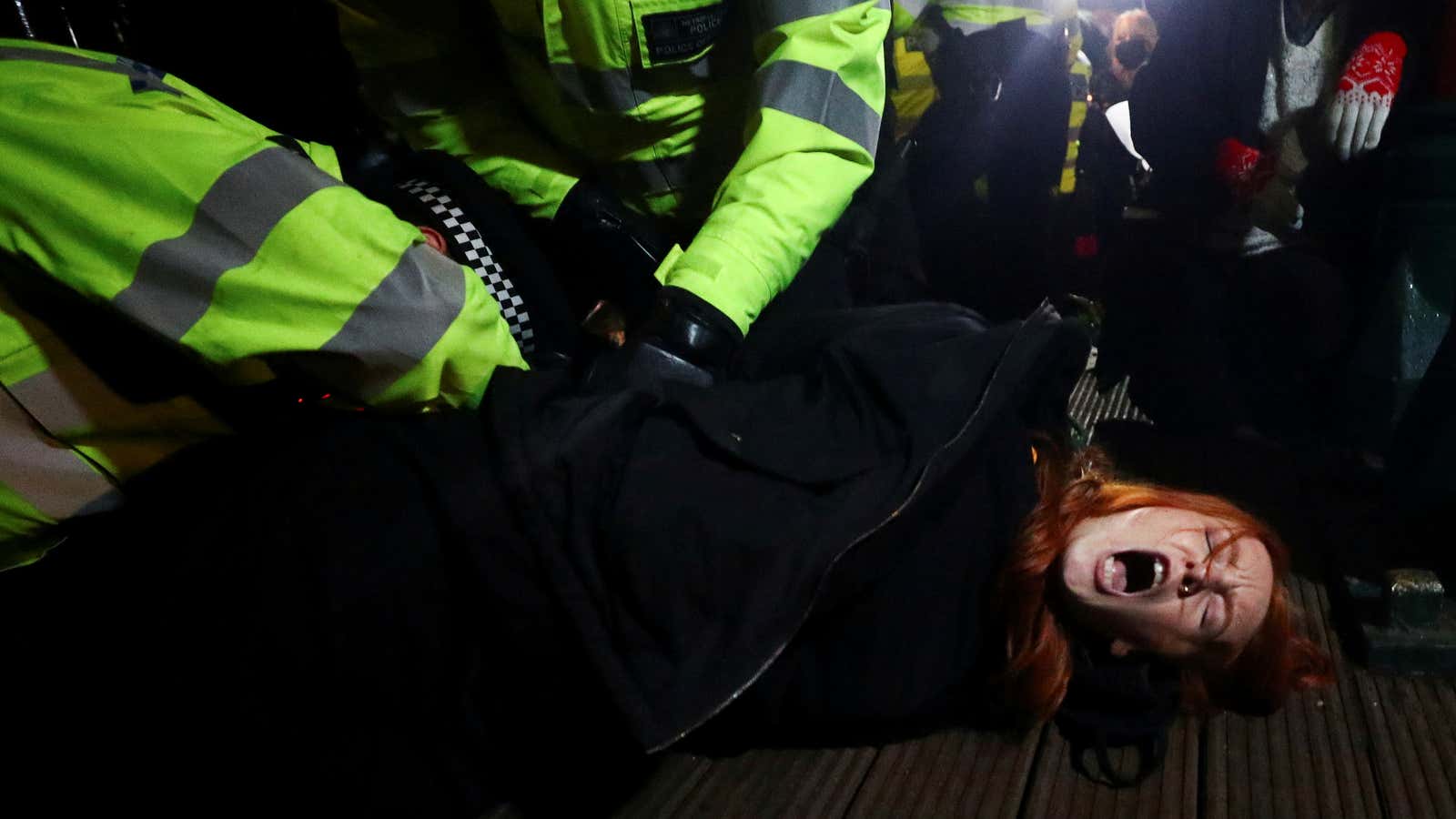 Police detain Patsy Stevenson at a memorial site in Clapham Common, following the kidnap and murder of Sarah Everard.