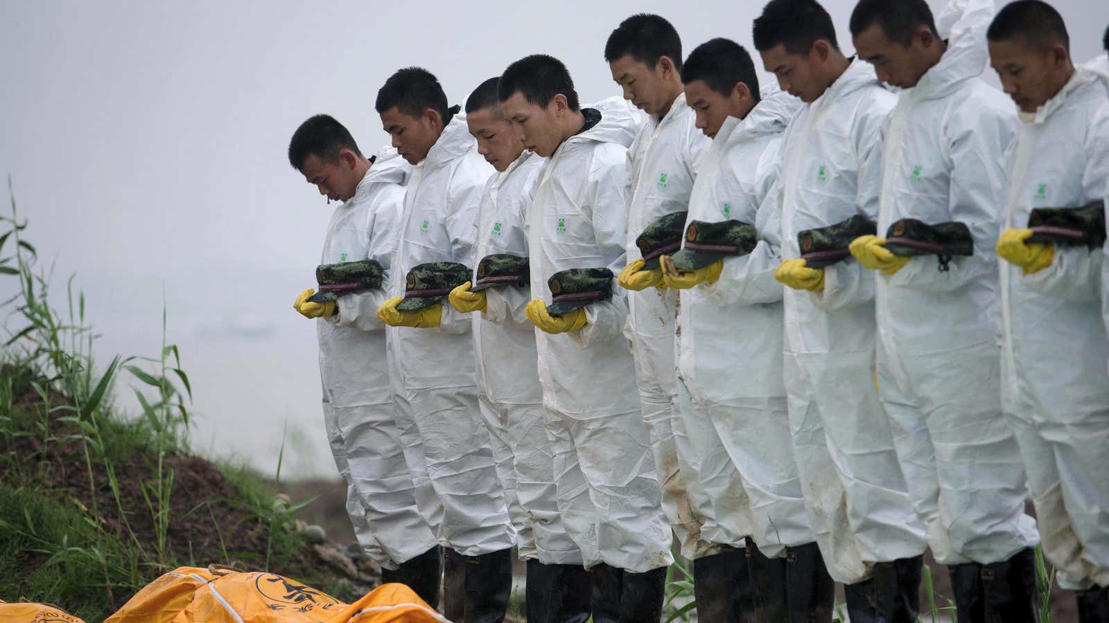 Rescue workers pay respects to victims of a cruise ship that sank in the Yangtze River in Hubei province.