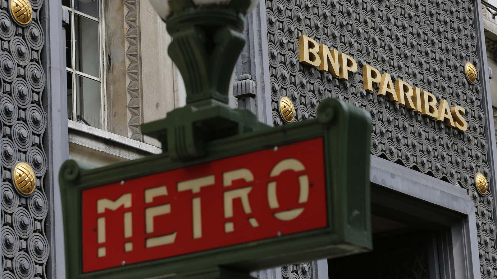 A Paris Metro underground sign is seen outside a central Paris agency of French bank BNP Paribas.