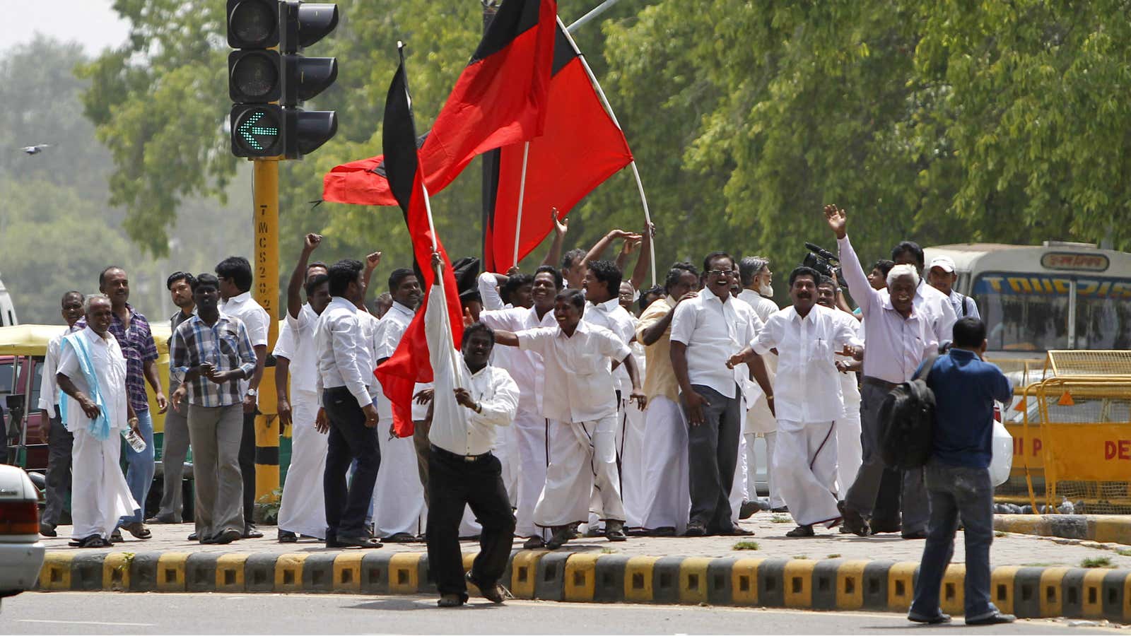 The Dravida Munnetra Kazhagam (DMK) party celebrates as its leader, at the center of a telecom corruption scandal, is released on bail in May. Today, the party withdrew support of the coalition government.