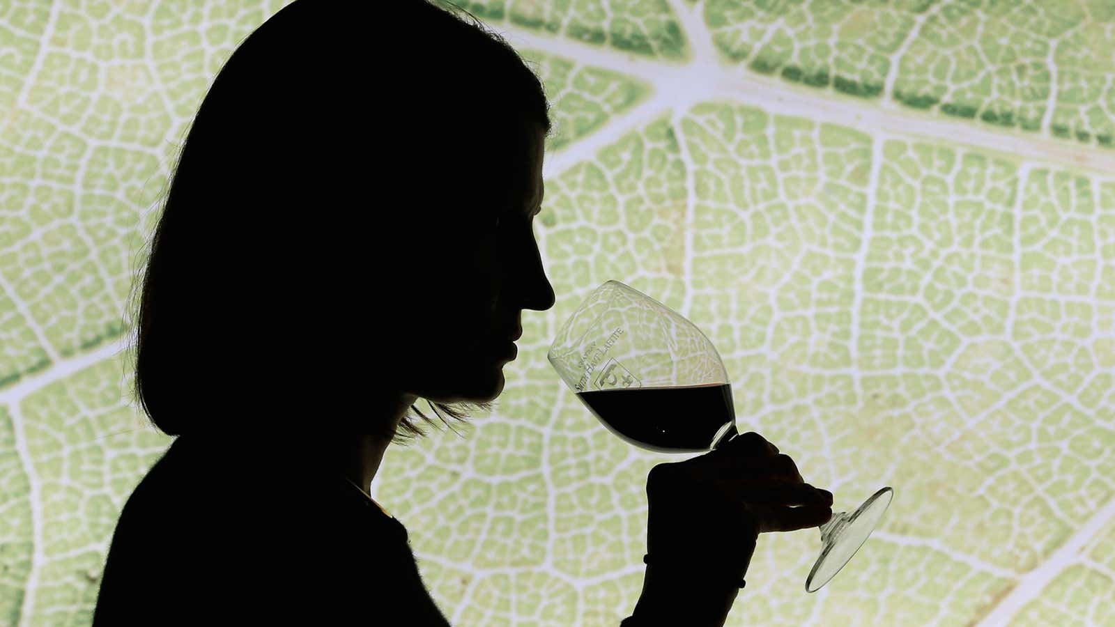 A woman tastes red wine in the cellar of Chateau Smith Haut Lafitte (Graves Pessac Leognan label) in Martillac, France, October 23, 2018.