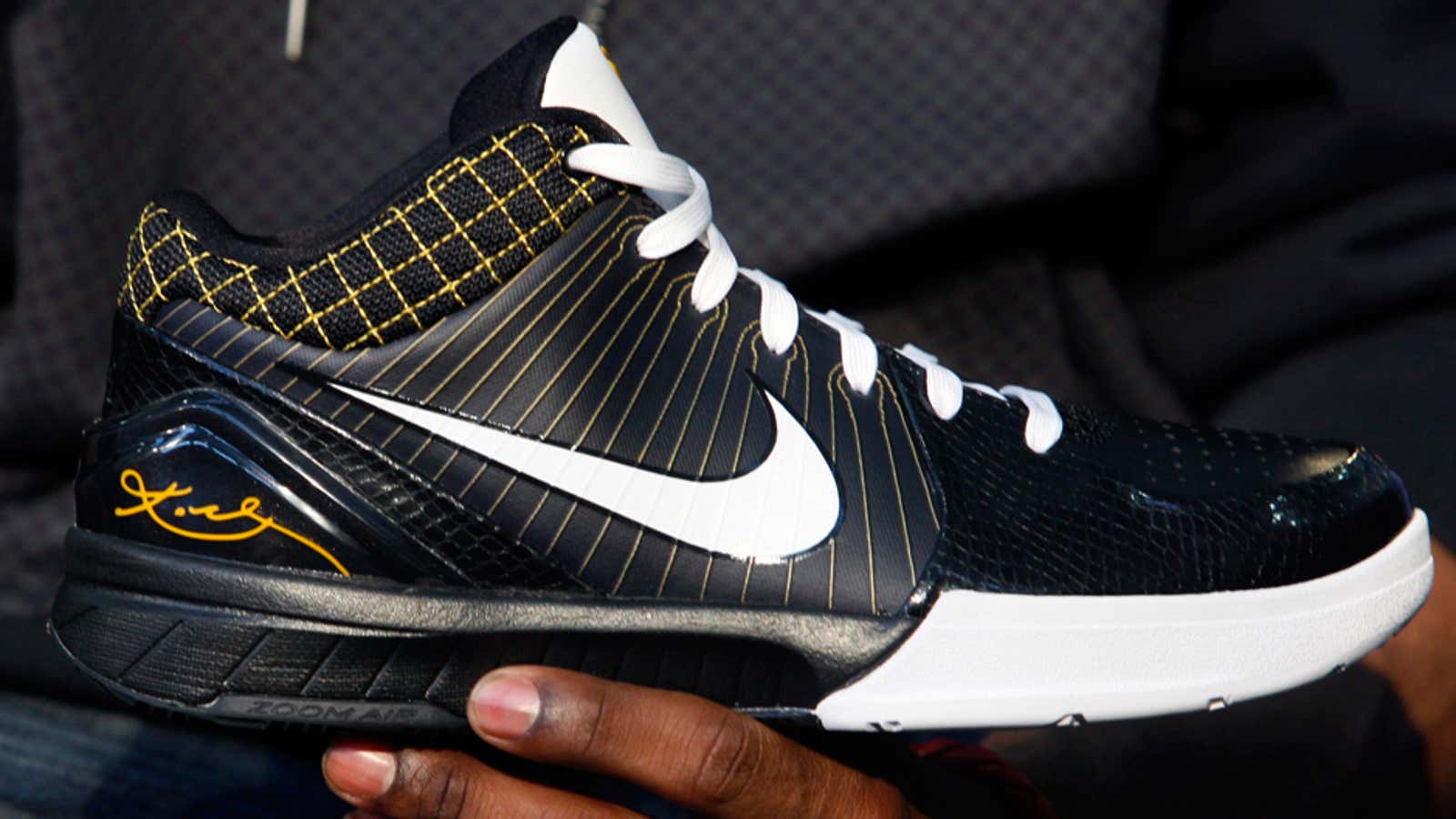 NBA star Kobe Bryant holds his new Nike Zoom Kobe IV basketball shoe.