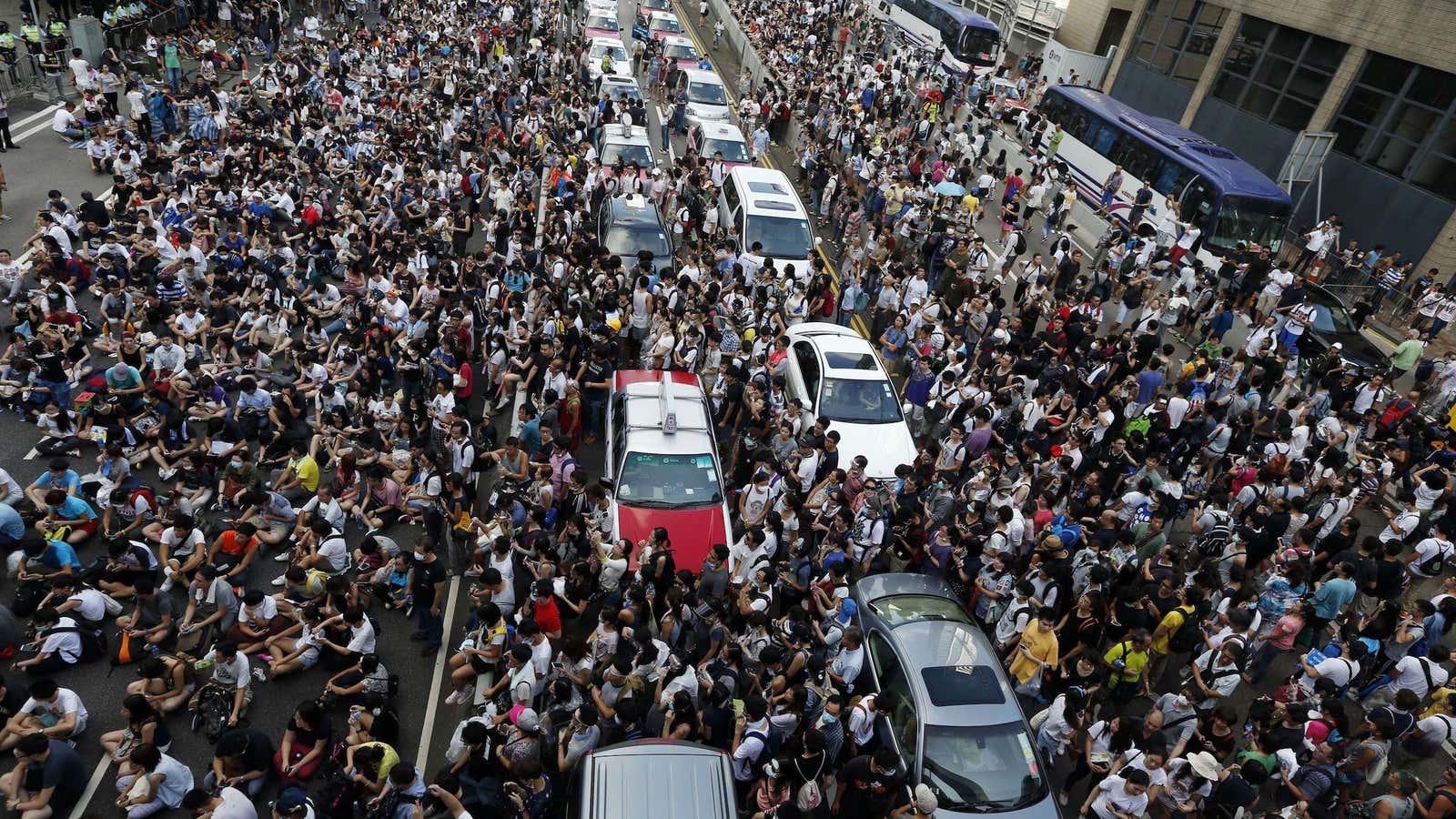 Protesters block traffic on a main road near the government headquarters in Hong Kong on Sept. 28.