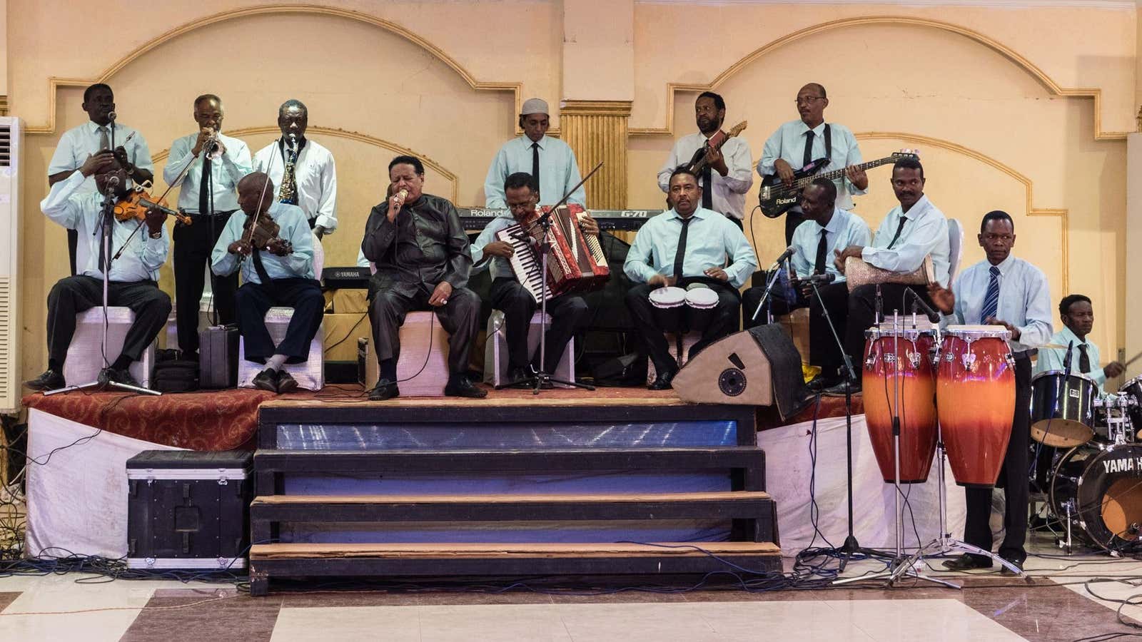 Legendary singer Salah Ben Al Badia (center in black) sings at a wedding in Omdurman, Sudan.