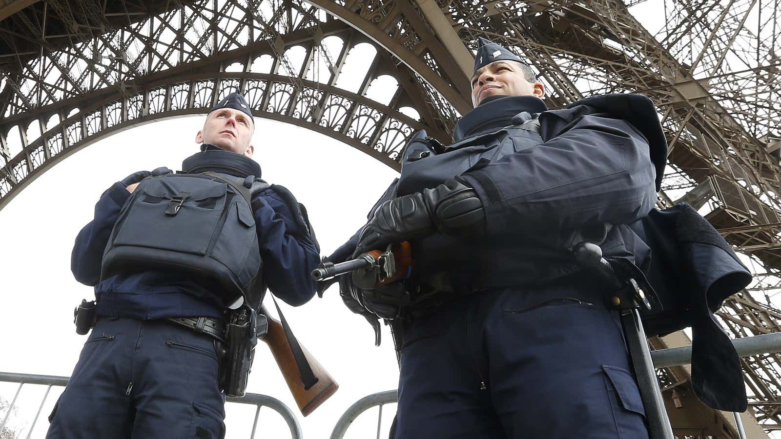 Police take up position under the Eiffel Tower the morning after a series of deadly attacks in Paris , November 14, 2015. REUTERS/Yves Herman –…