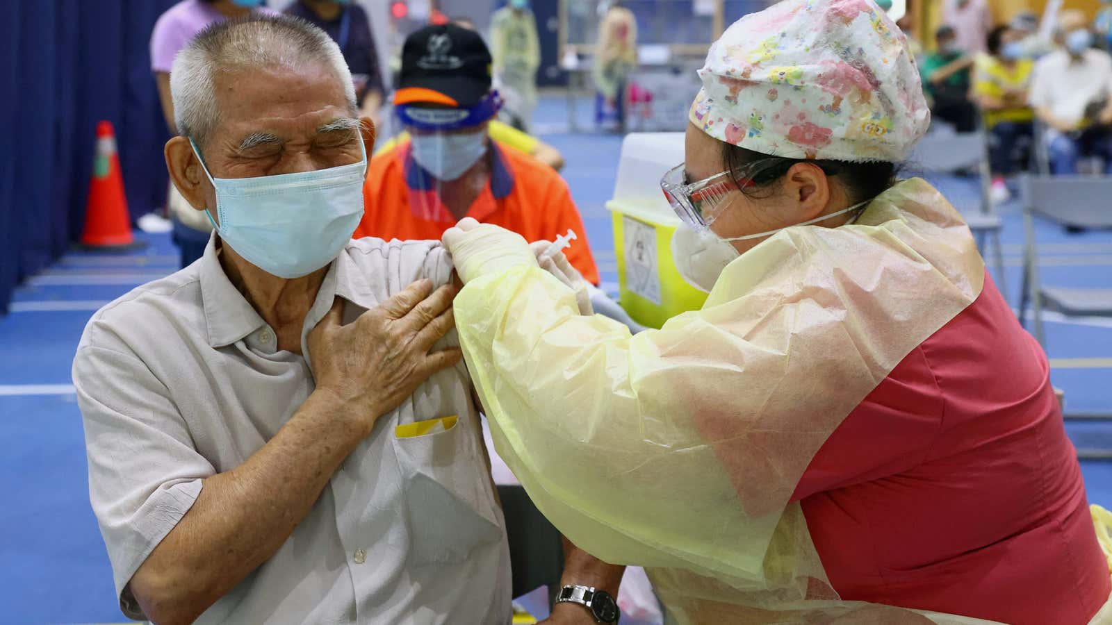 FILE PHOTO: A medical worker administers a dose of the AstraZeneca vaccine against the coronavirus disease (COVID-19) to a man during a vaccination session for…