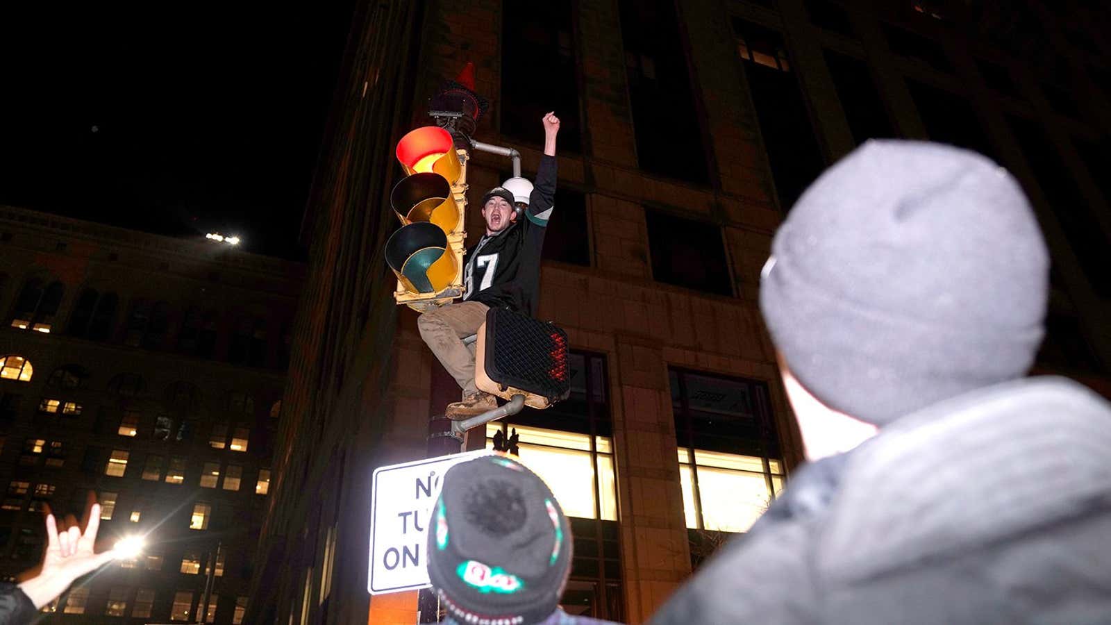 Scaling the traffic light of victory.