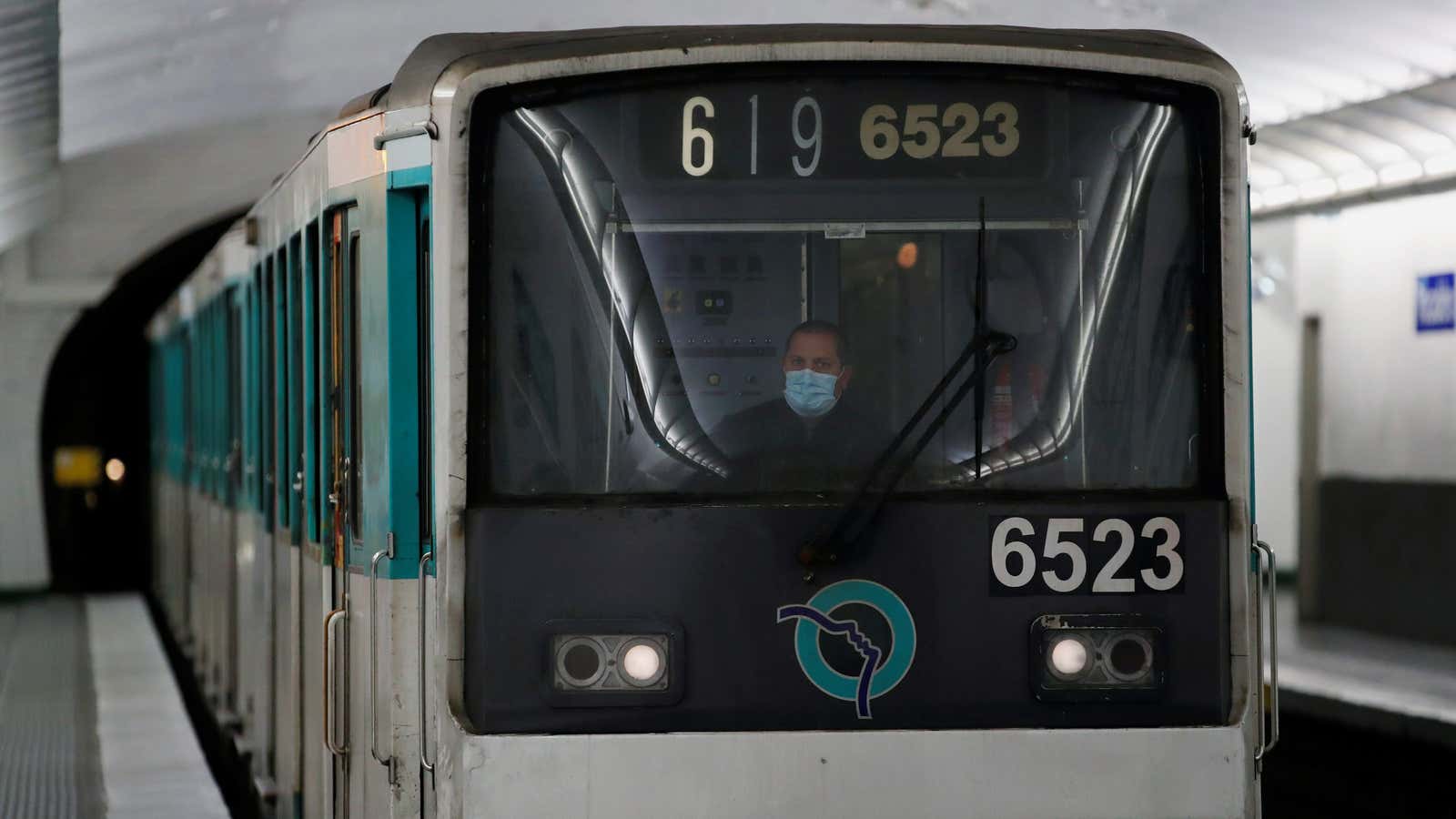 An employee of transport network (RATP) metro wearing a protective face mask drives a metro as a lockdown is imposed to slow the rate of…