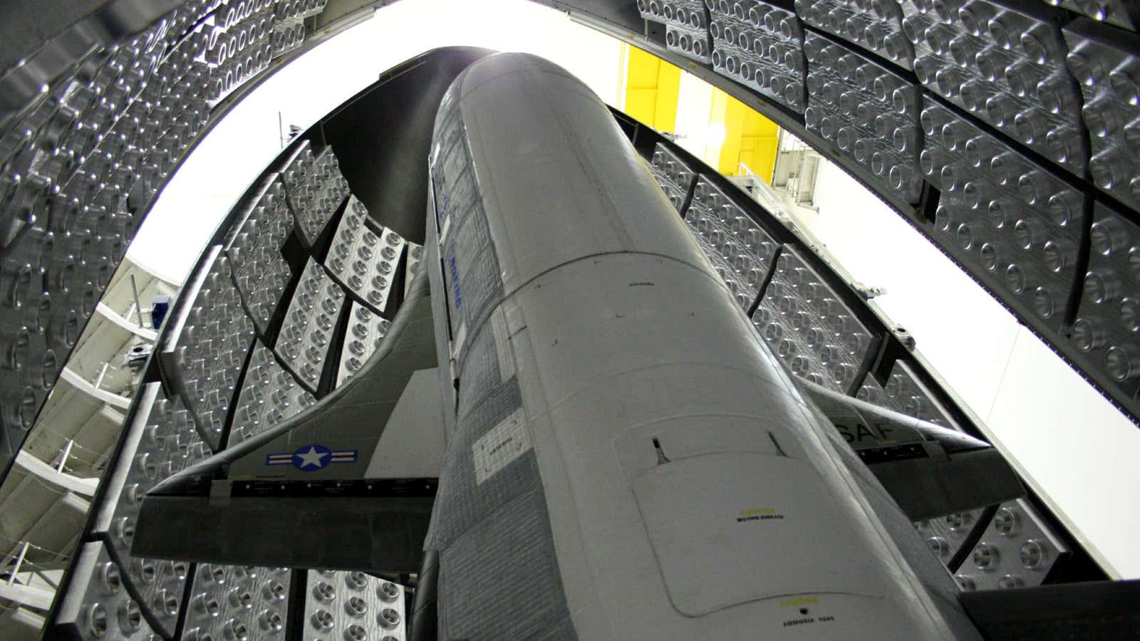 The X-37B, tucked inside the aerodynamic shell that will protect it on its way to space.