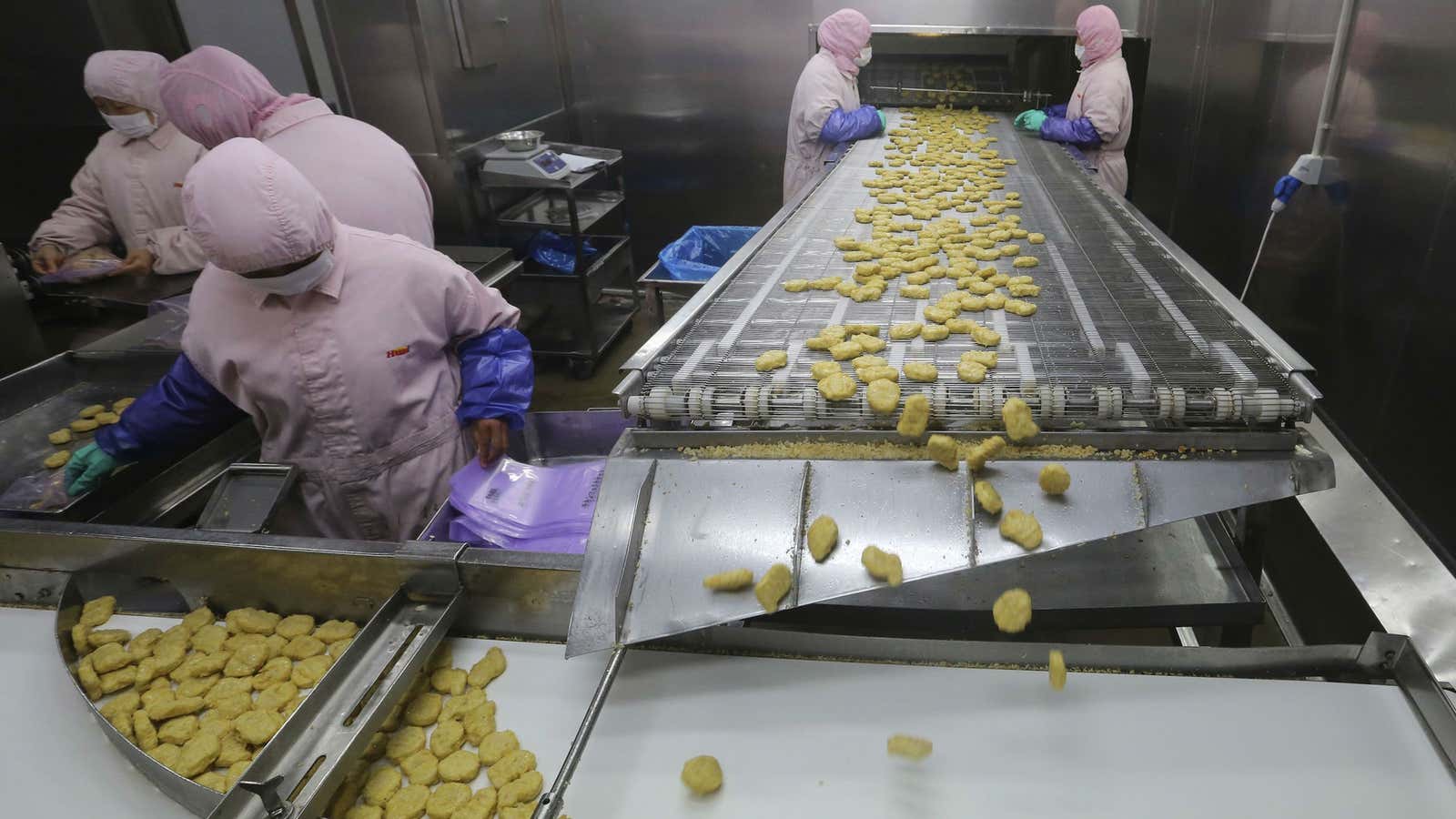 Workers at Husi Food factory in Shanghai before authorities suspended the plant.