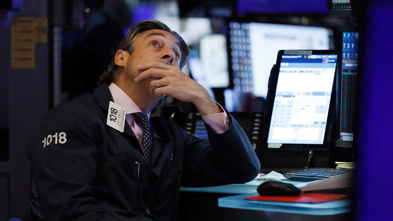 Trader John Romolo works on the floor of the New York Stock Exchange, Wednesday, Aug. 7, 2019. U.S. stocks fell broadly in midday trading Wednesday as central banks around the world cut interest rates and increased fears that global growth is being crimped by the U.S.-China trade war. (AP Photo/Richard Drew)