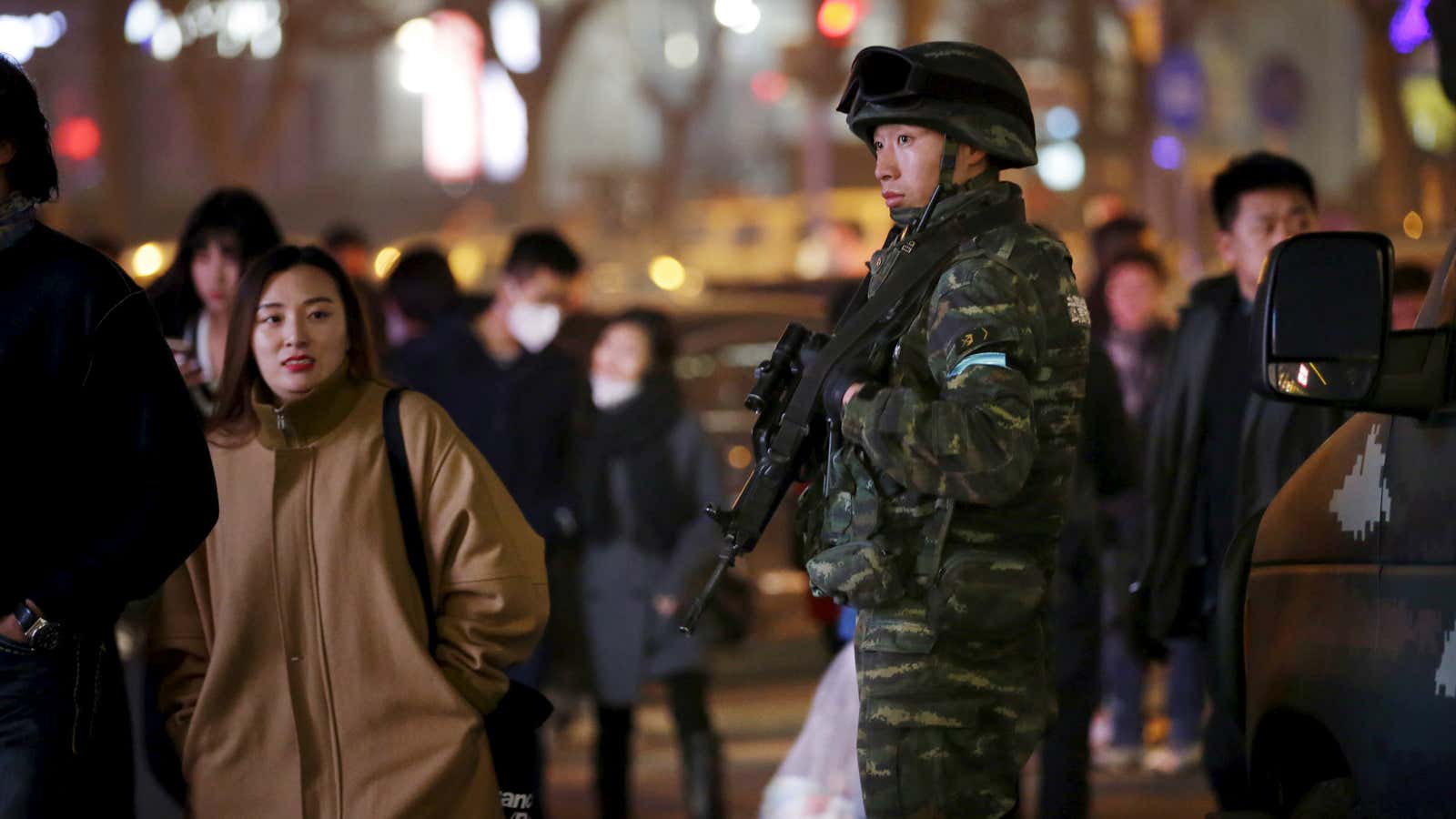 Shopping under the protection of armed guards.