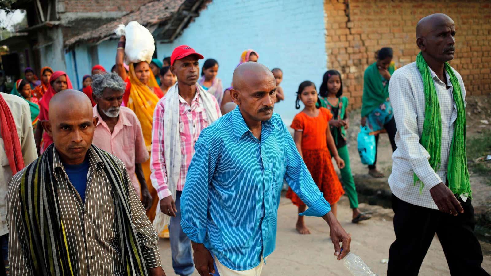 The family of a woman, who died in a sterilisation camp, walk during her funeral in November 24.