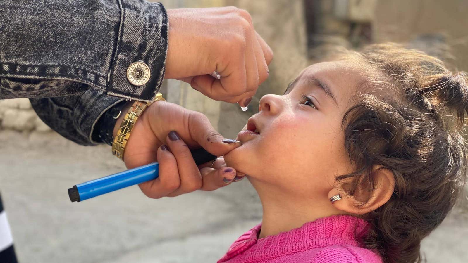 In February, the Covid-19 pandemic halted polio immunization campaigns across Afghanistan and Pakistan, fueling a new resurgence of polio in children. Here, a young girl is given the polio vaccine in the Kabul Province in October after campaigns were resumed.