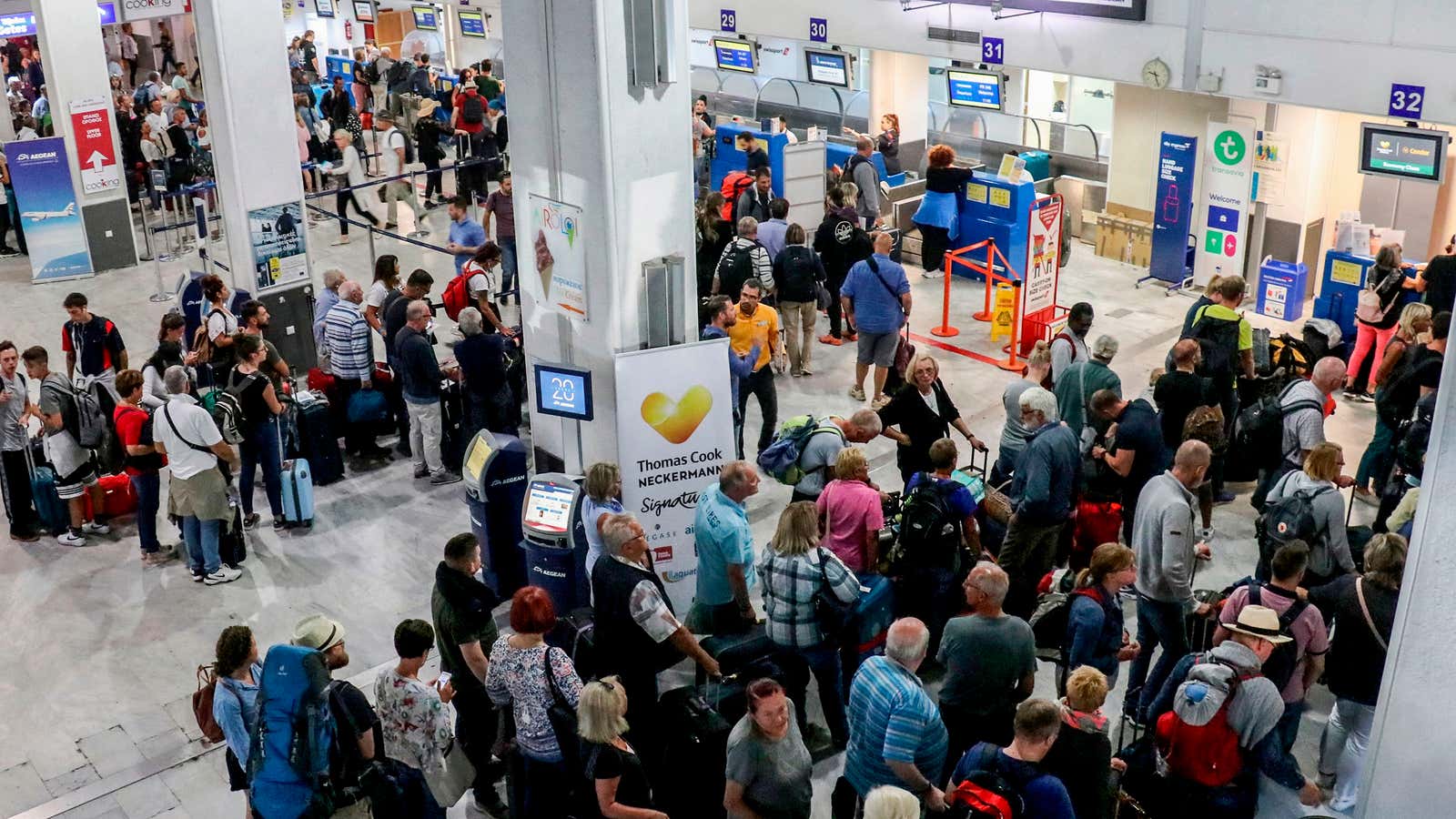 Tourists wait at a Thomas Cook company counter at Heraklion airport on the island of Crete on Sept. 23.