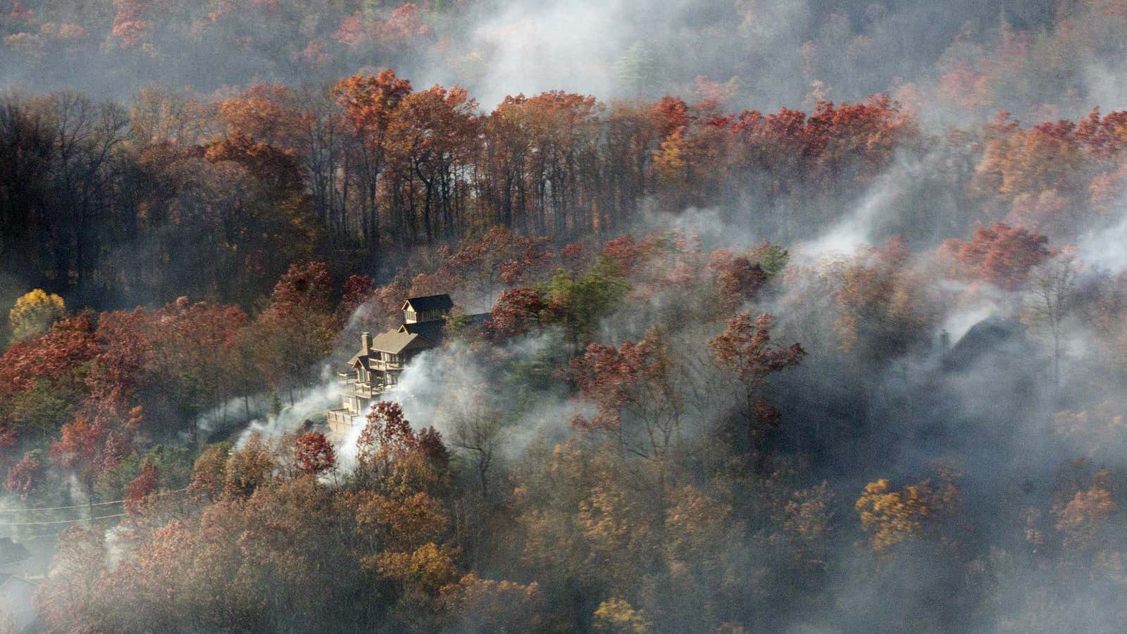 Smoke from a deadly wildfire engulfs a home near Gatlinburg, Tennessee.