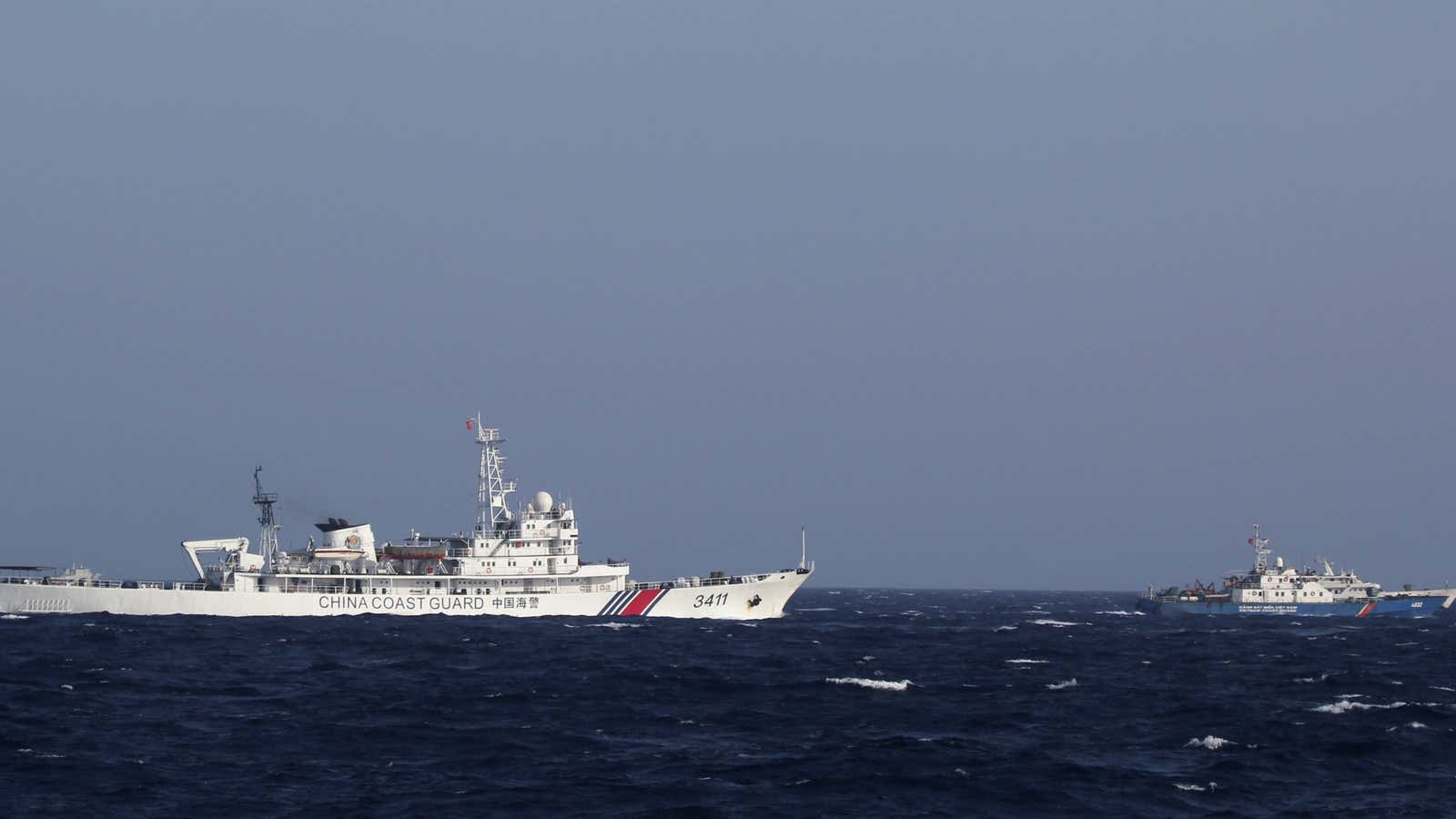 Chinese and Vietnamese coast guard ships patrol disputed waters near China’s oil rig.