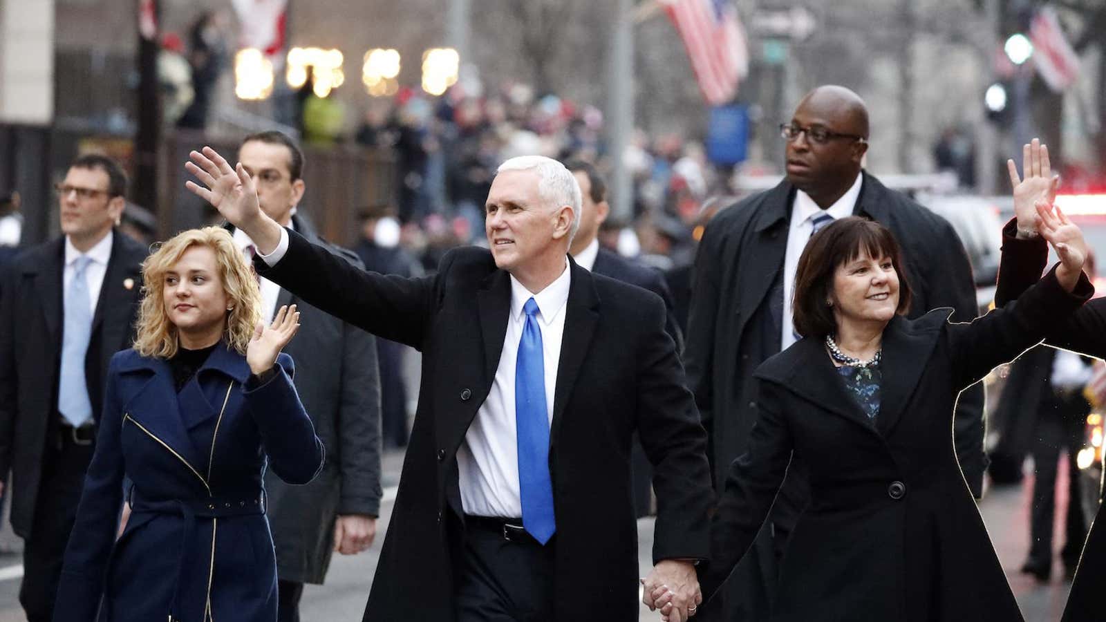 Vice President Mike Pence walks in the inauguration parade in Washington, Friday, Jan. 20, 2017, with his wife Karen and daughter Charlotte, left. (AP Photo/Alex Brandon)