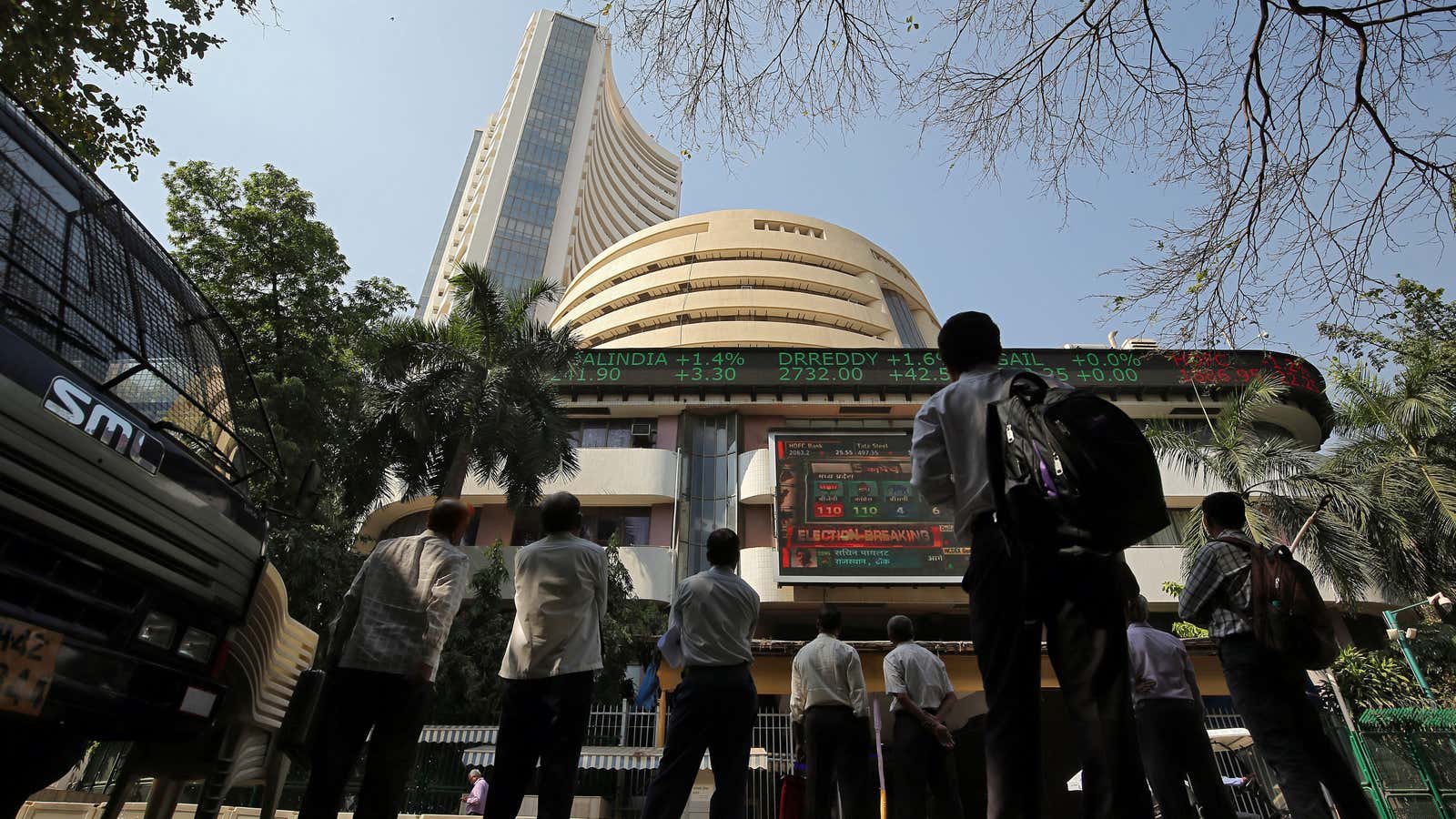 People look at a screen displaying the Sensex results on the facade of the Bombay Stock Exchange (BSE) building in Mumbai, India, December 11, 2018.…