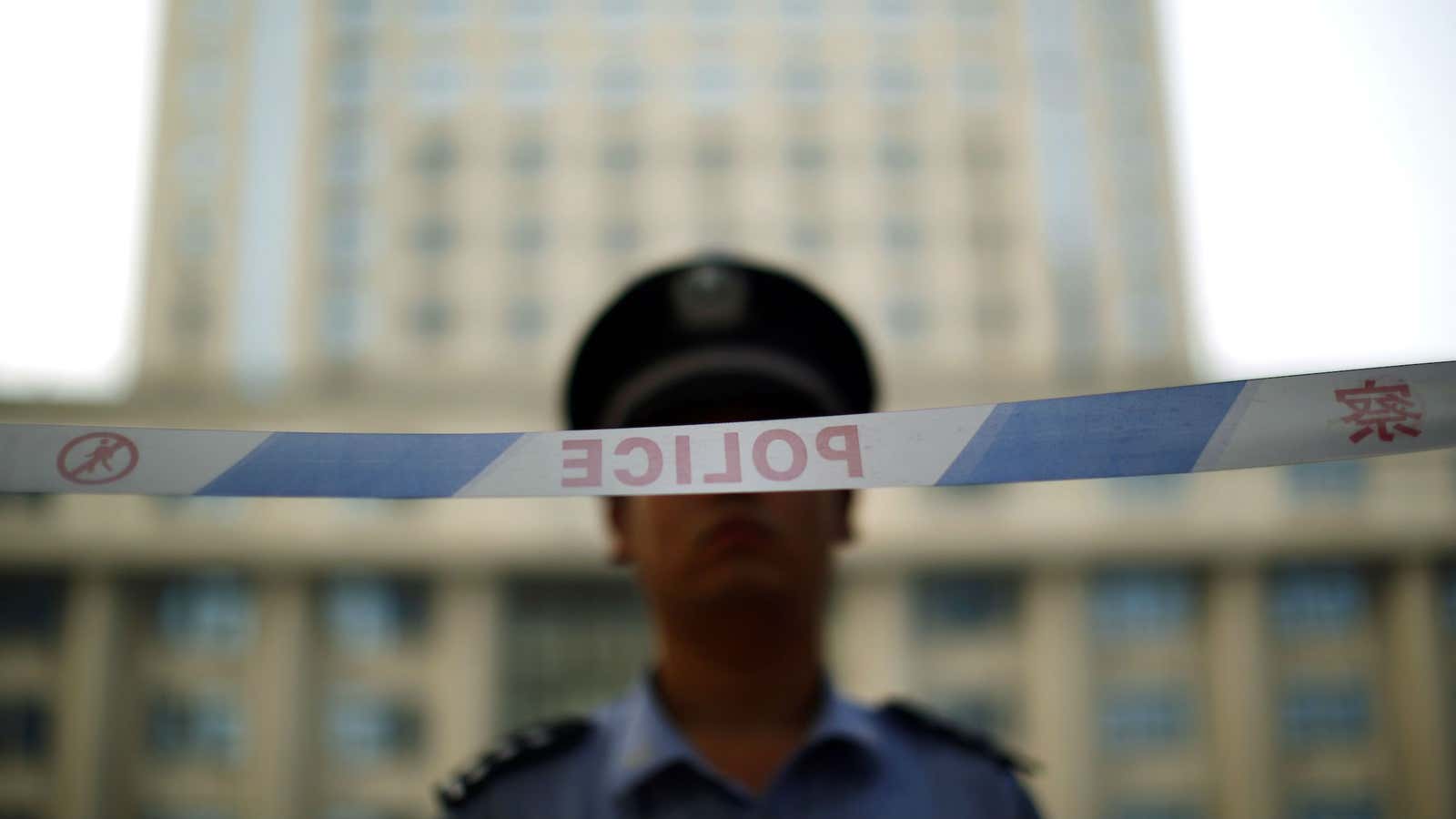 A policeman stands guard outside a Chinese courthouse.