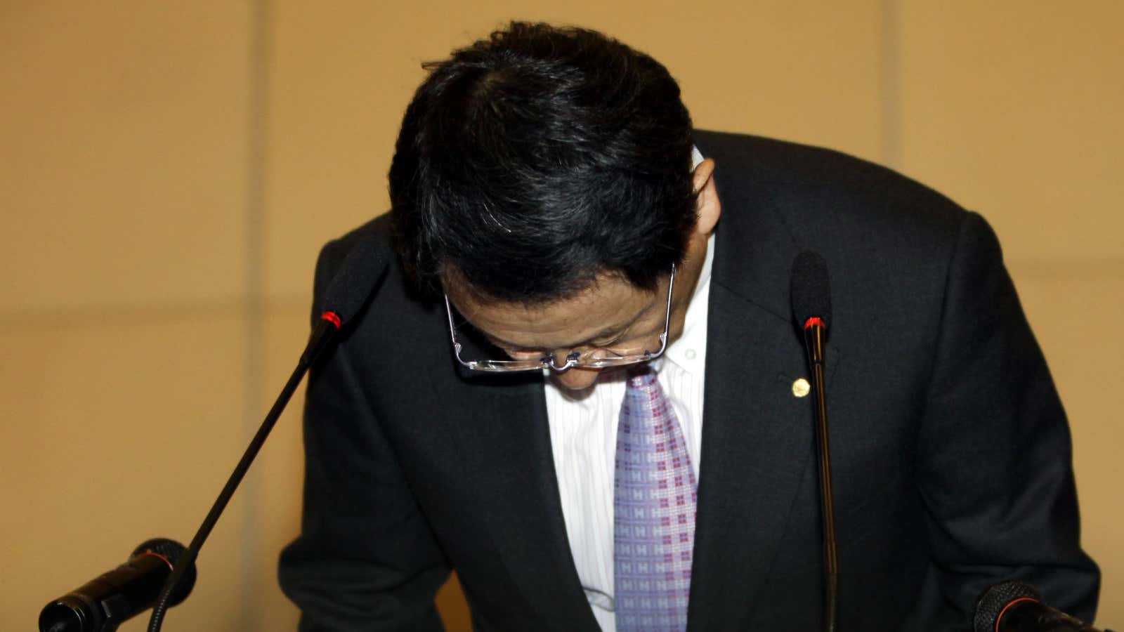 Toyoto Motor president and CEO Akio Toyoda bows during a press conference in Beijing.