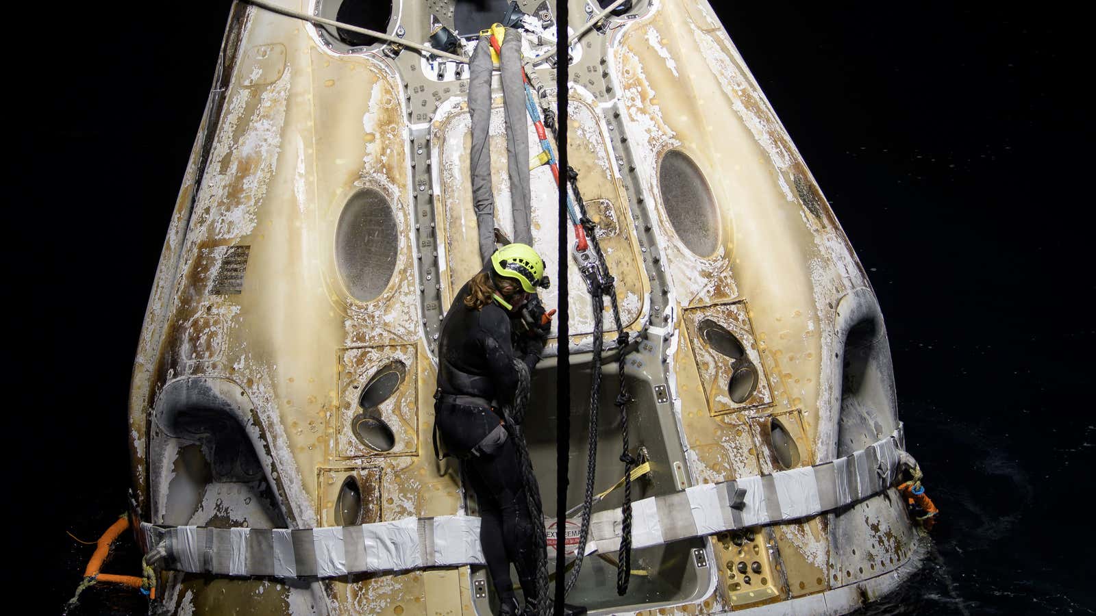 Support teams work around the SpaceX Crew Dragon Resilience spacecraft shortly after it landed with NASA astronauts Mike Hopkins, Shannon Walker, and Victor Glover, and…