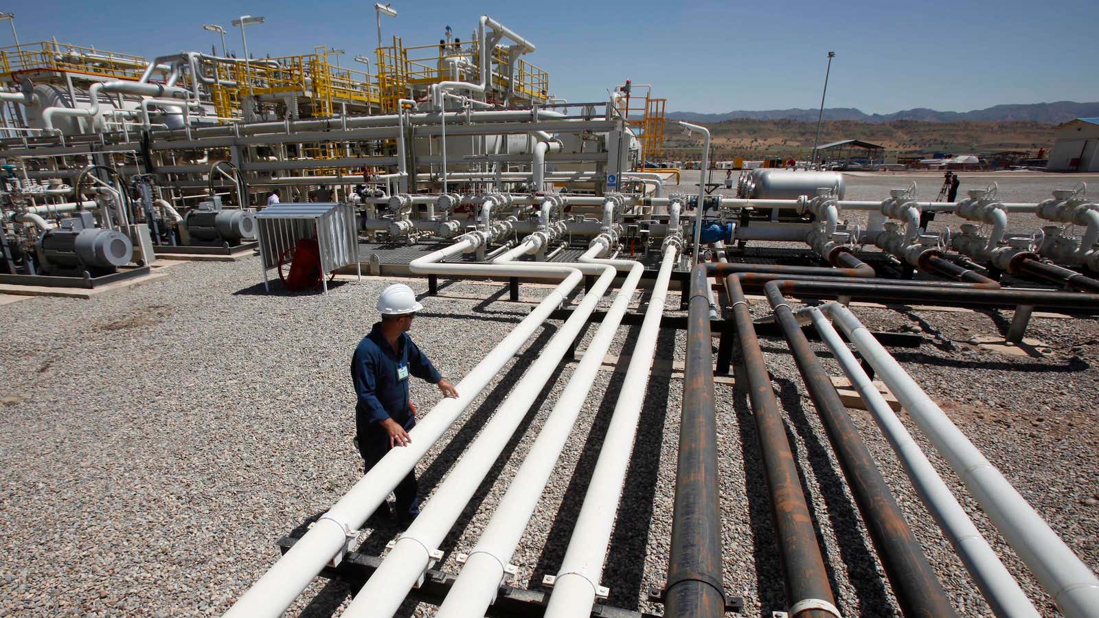 FILE – In this May 31, 2009 file photo, an employee works at the Tawke oil fields in the semiautonomous Kurdish region in northern Iraq.…