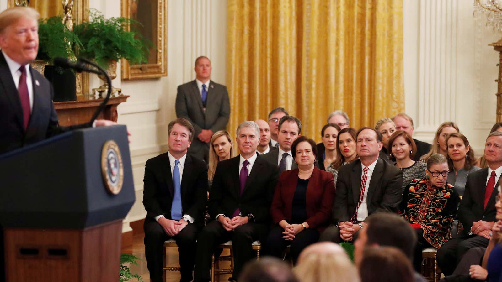 The justices watch Trump award Medals of Freedom.