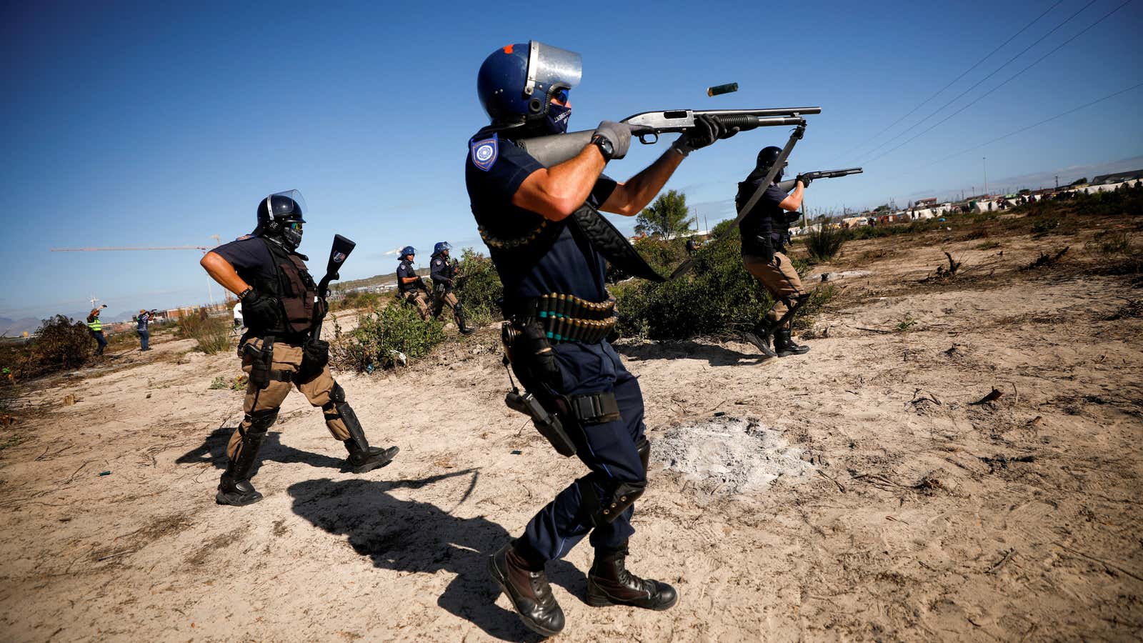 Police fire shotguns and teargas as they attempt to disperse Khayelitsha township residents during a nationwide lockdown in Cape Town, South Africa April 21, 2020.